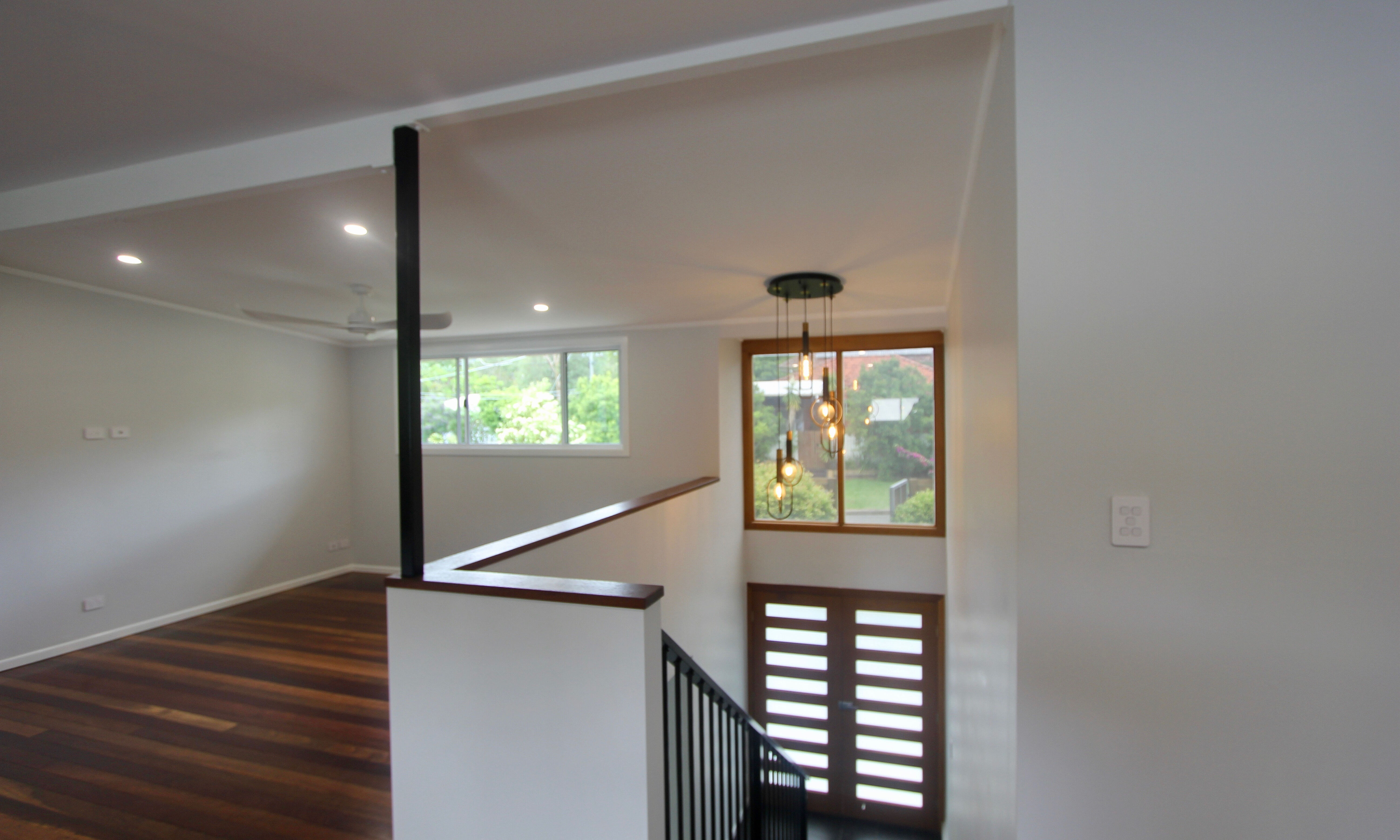 Double doors in front entry and stairs with powder coated dowel balustrade