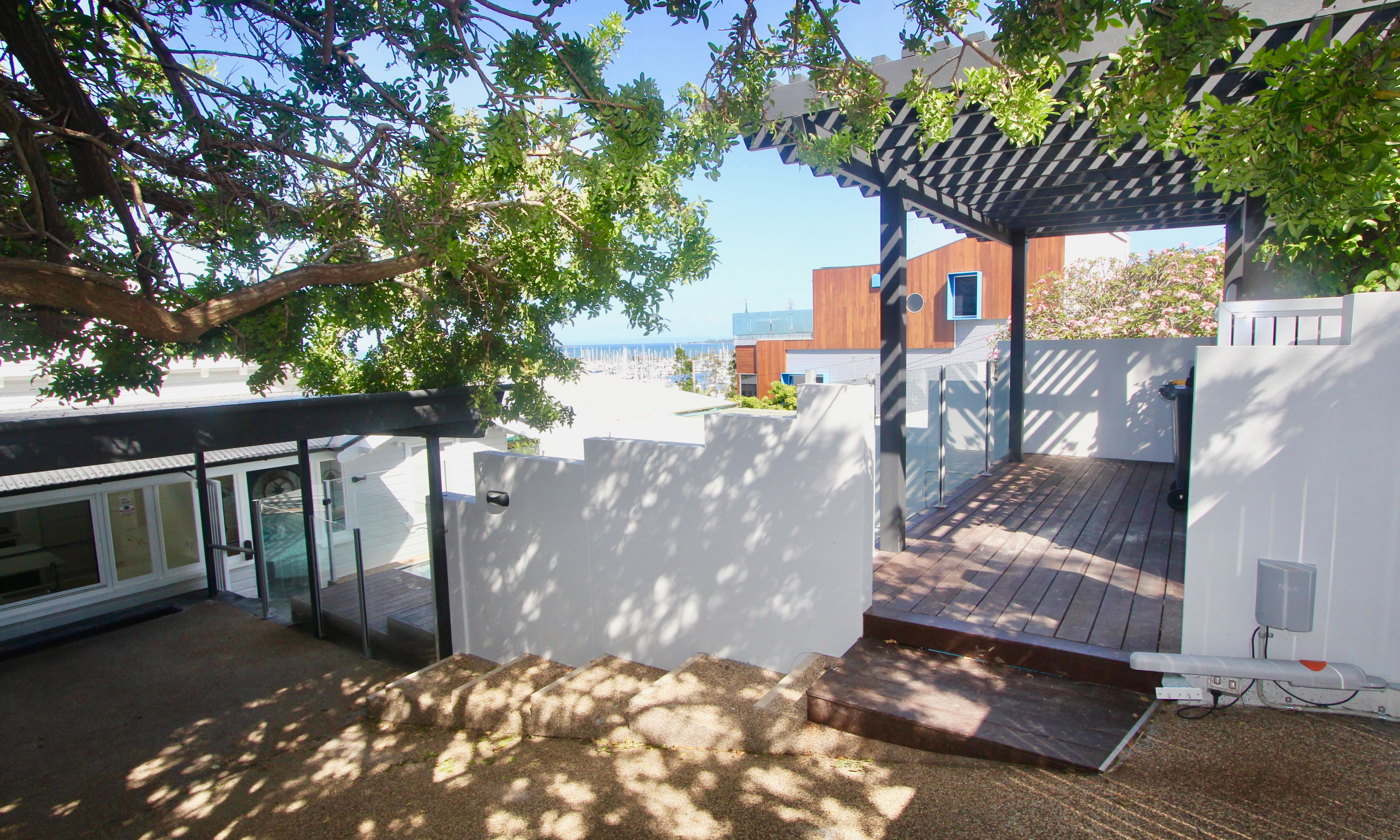 Rendered wall and timber pergola