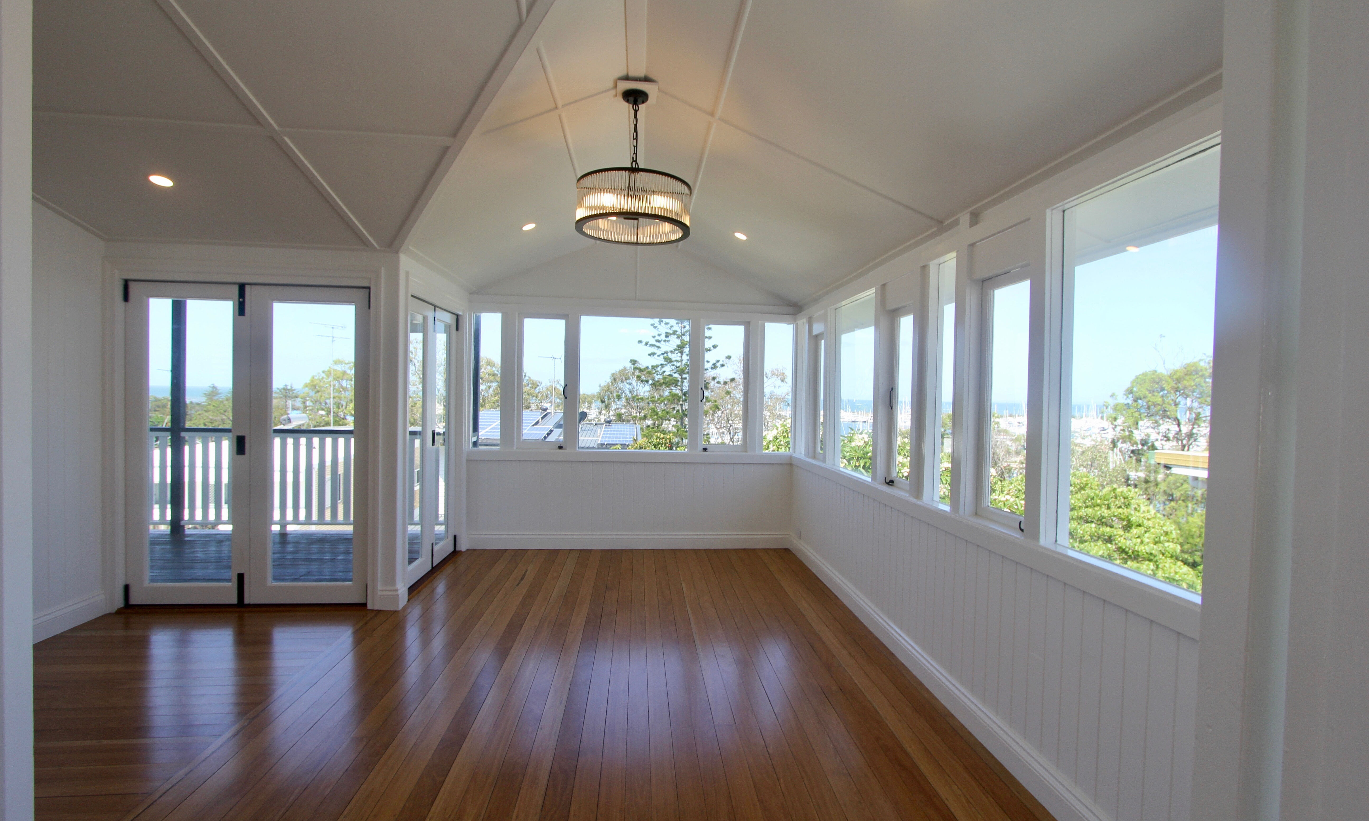 Bifold doors, Timber floors and pendant light in dining room