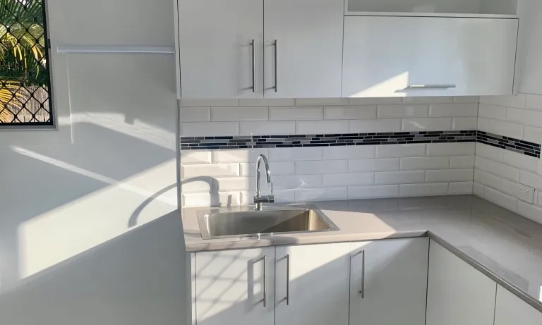 laundry renovation-floor tiles-subway tiles-white cabinets