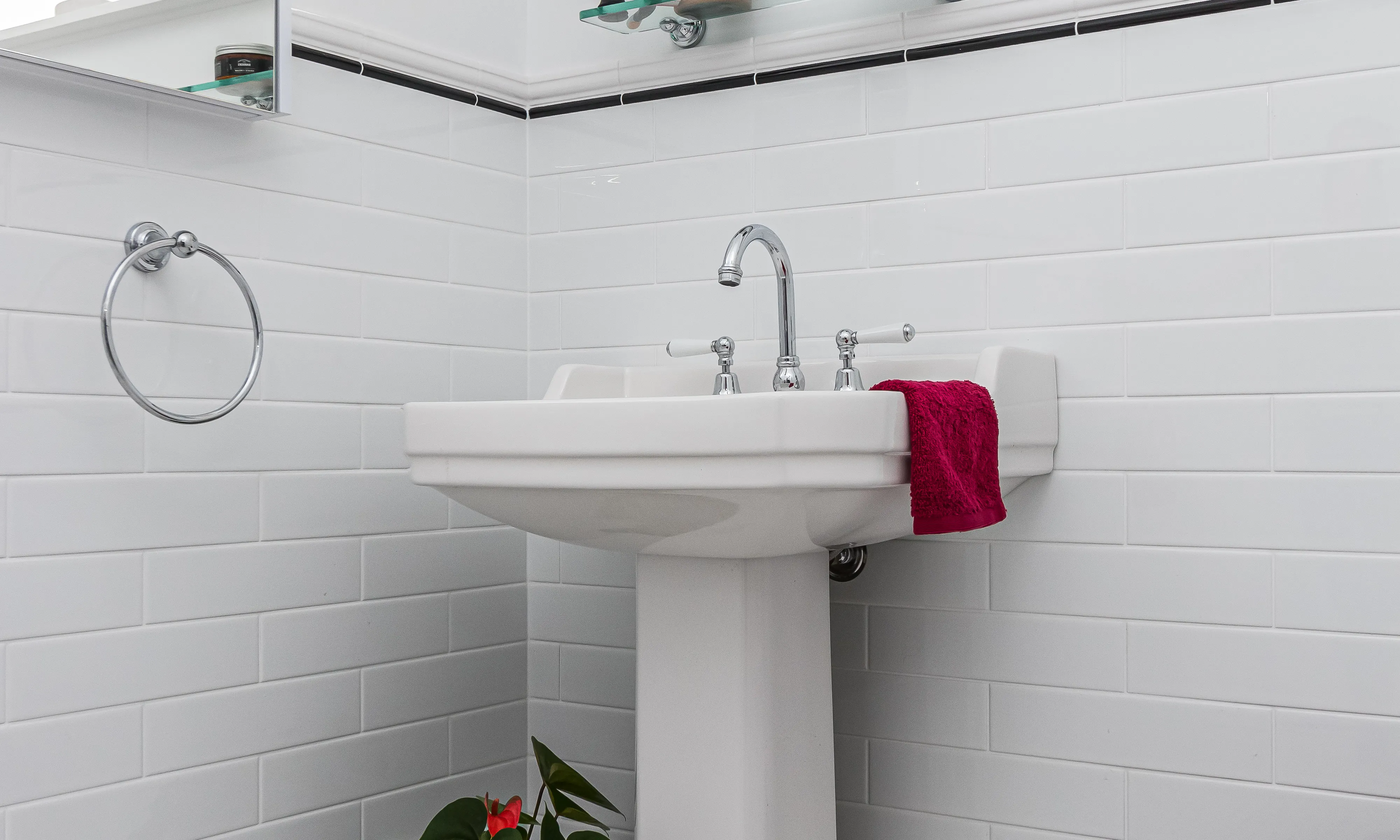 Pedestal Basin and black and white tiles in bathroom