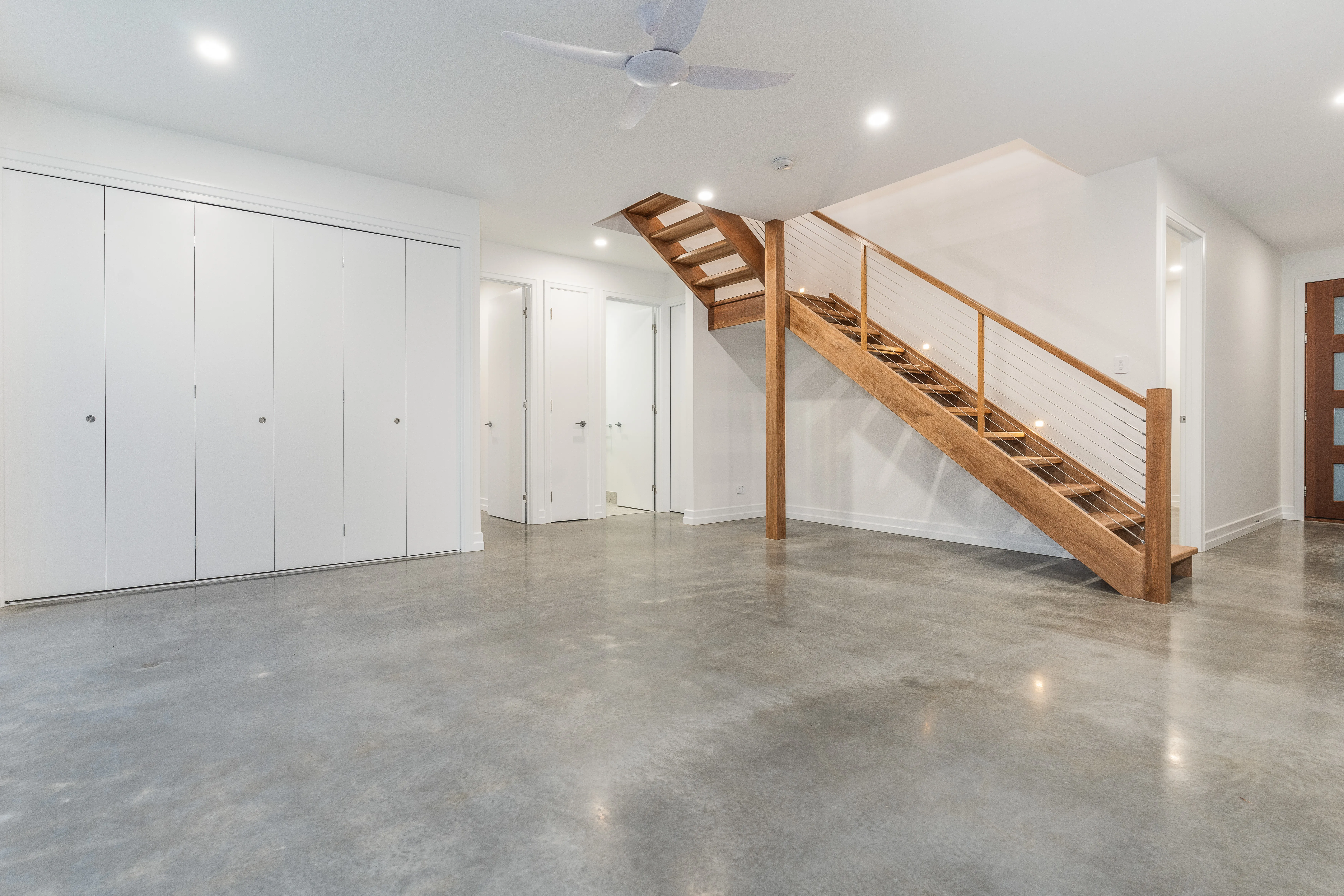 polished concrete floors-bifold doors-wire balustrade-timber handrail- timber stairs