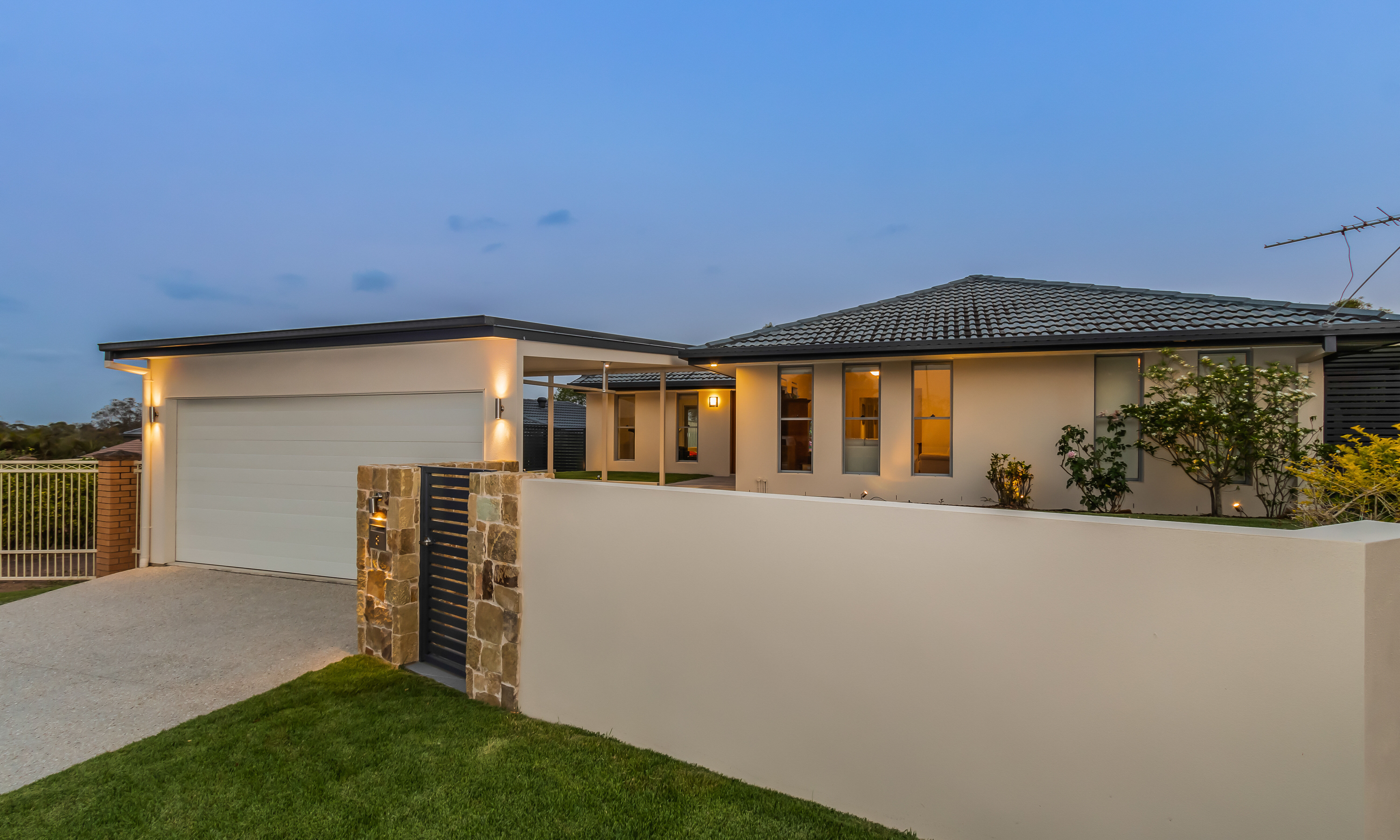 Carport, rendered feature wall, panel lift door