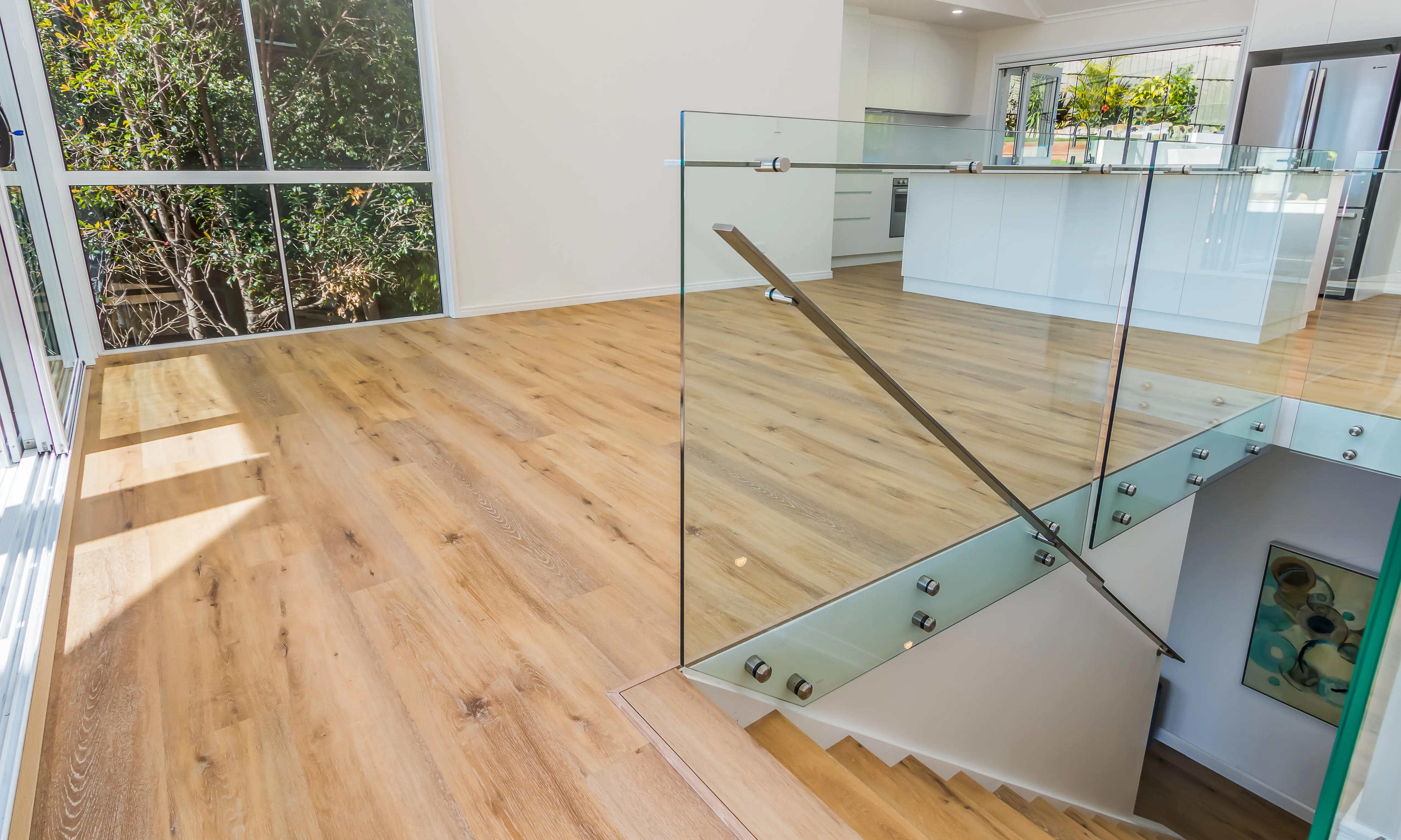 Frameless glass balustrade on standoffs-timber floors-open plan living