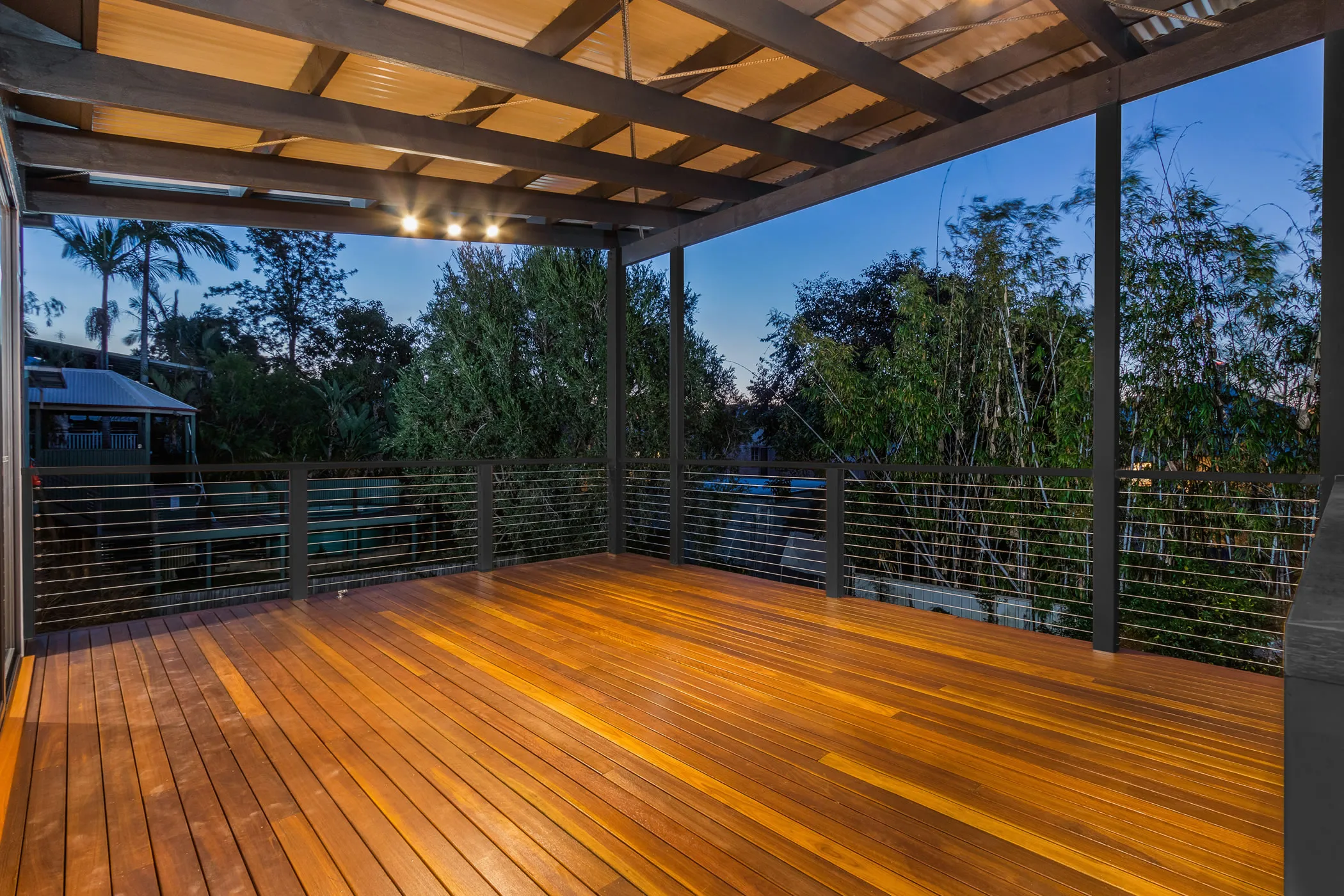Large deck with Spotted Gum decking boards and wire balustrade 