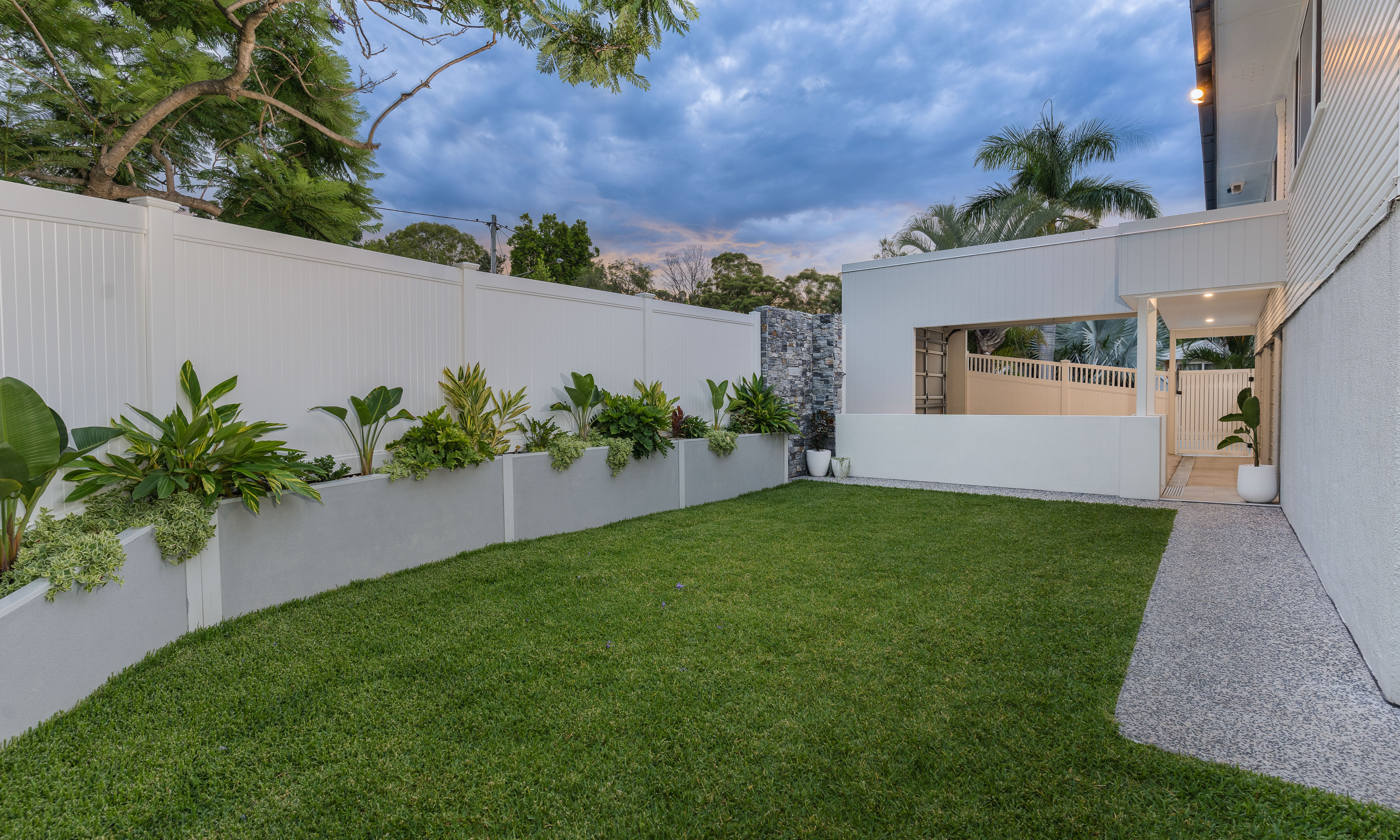 Front yard-stone cladding-lights-raise garden beds-carport-landscaping