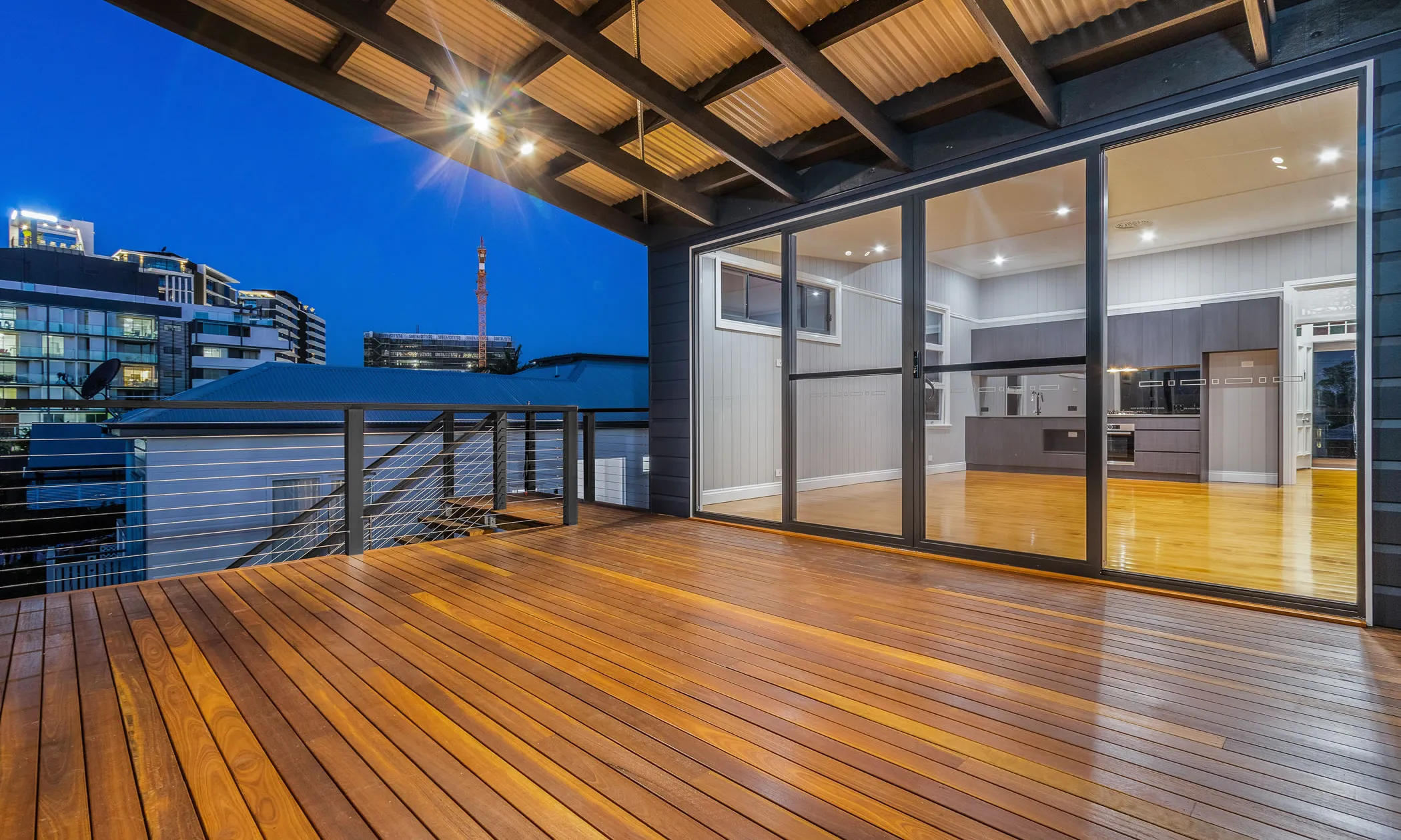 Large rear deck with wire balustrade and Spotted Gum decking boards