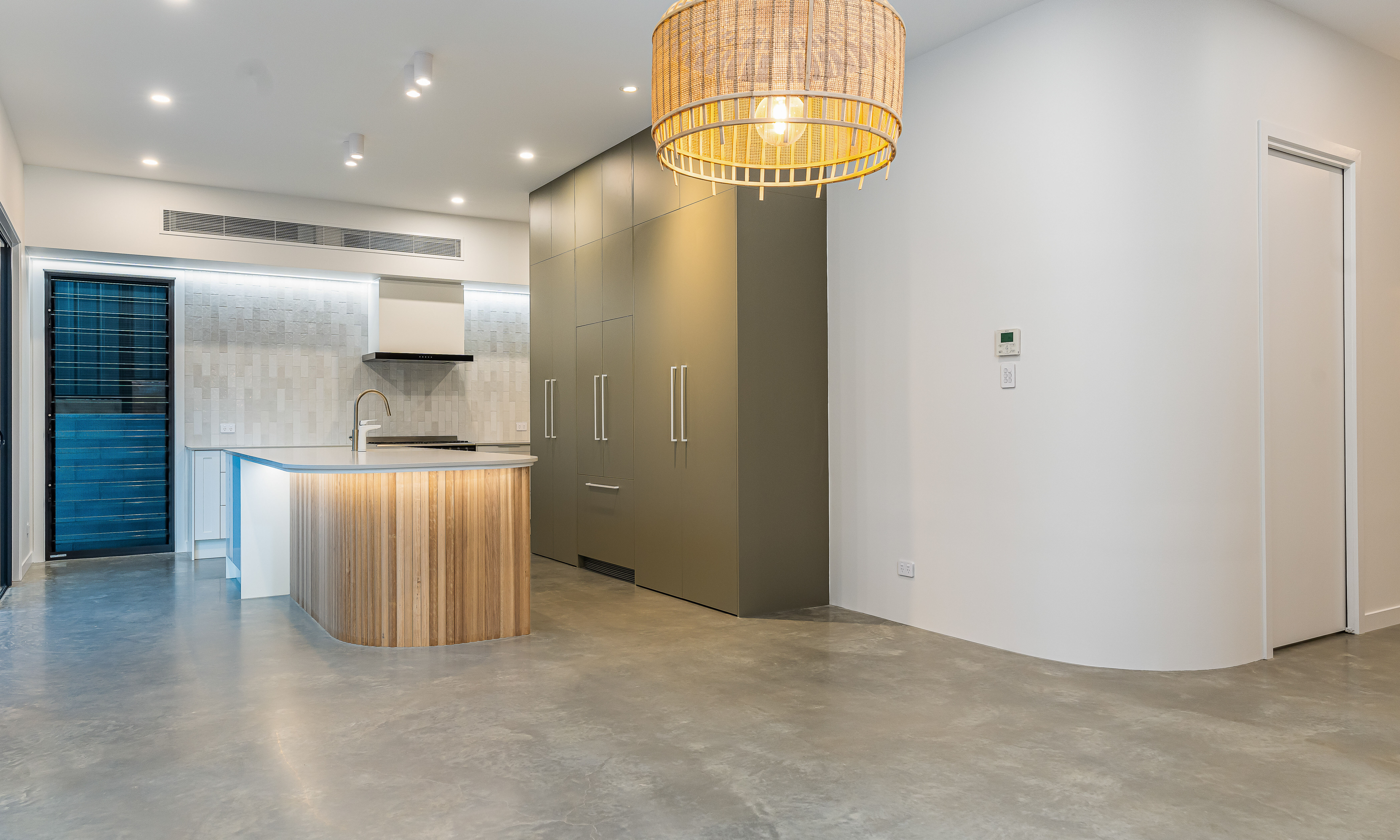 Kitchen island-tall cabinetry-splashback-subway tiles-polished floors