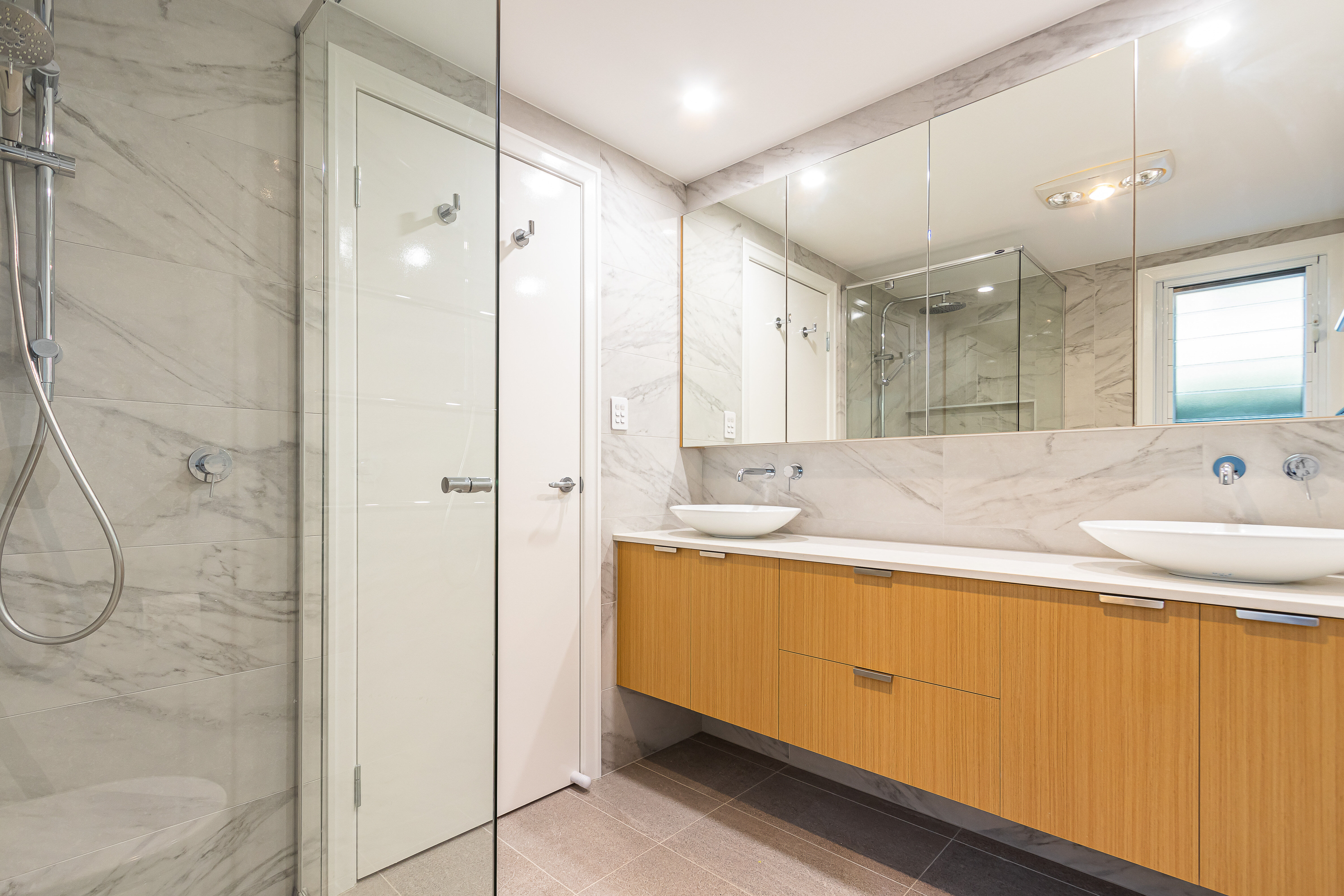 Double above counter basins and floating vanity in Norman Park