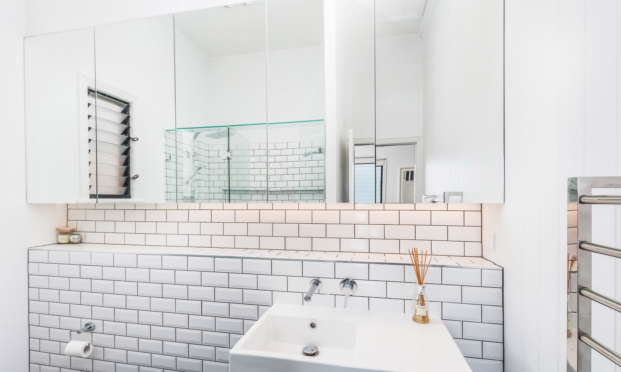 Tiles shelf with white subway tiles in bathroom