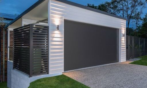 Garage door closed and white weatherboard 