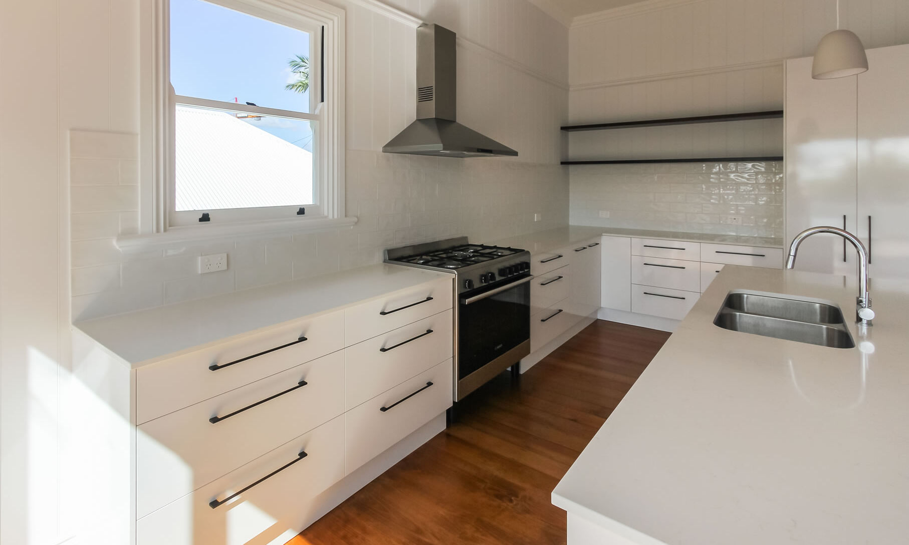 White kitchen with white subway tiles