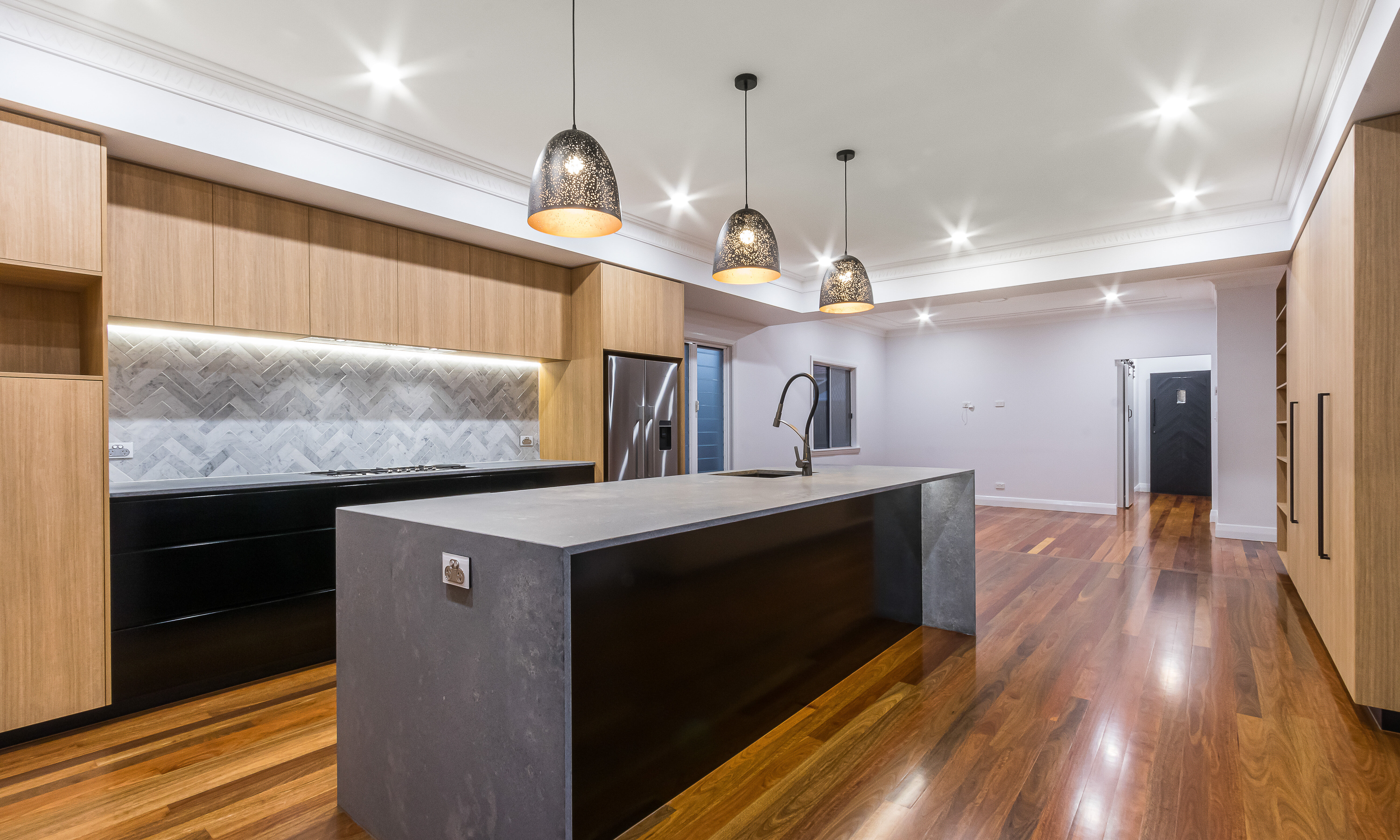 timber kitchen-stone benchtop- timber flooring- black handles- black cabinets-marble tiles