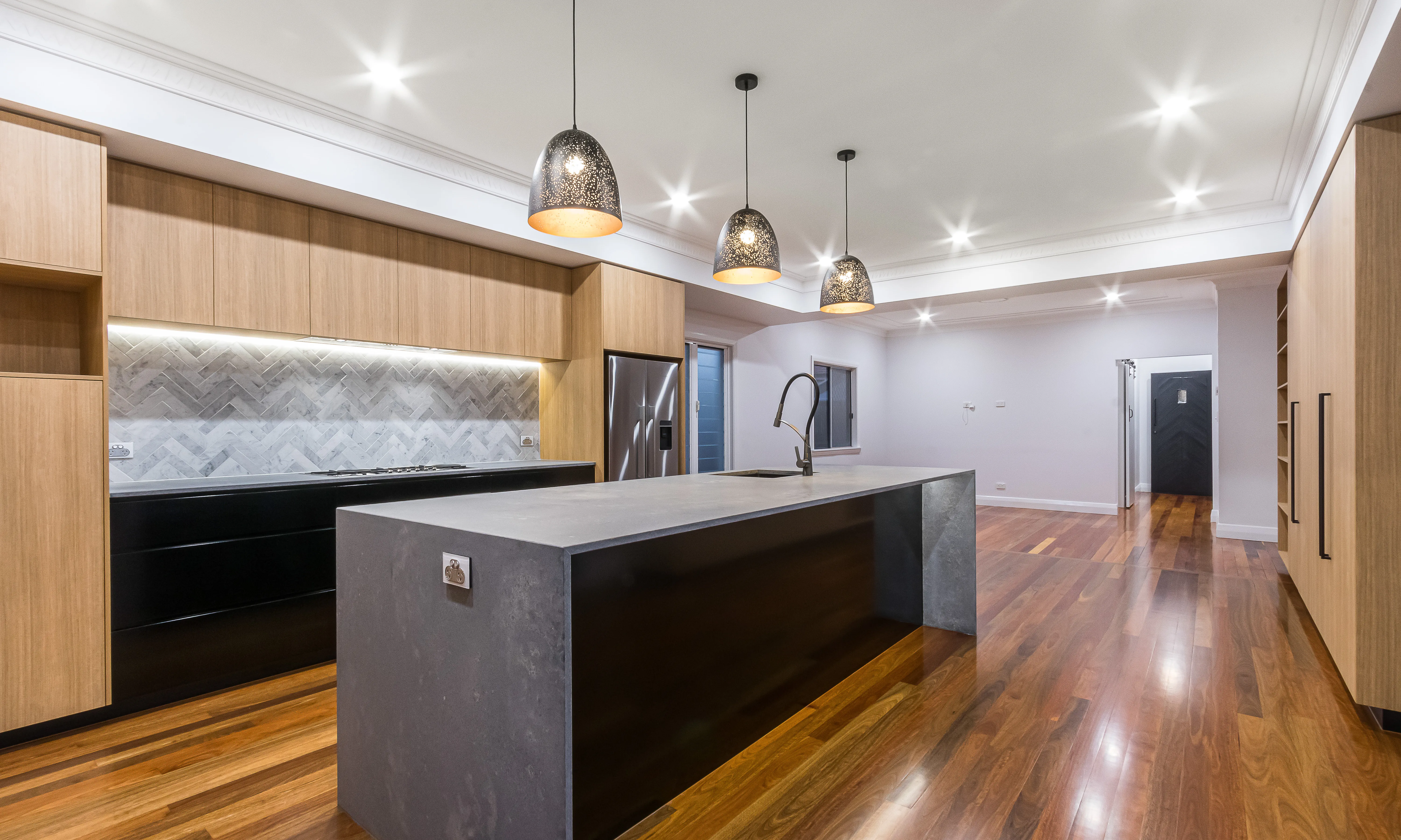 timber kitchen-stone benchtop- timber flooring- black handles- black cabinets-marble tiles