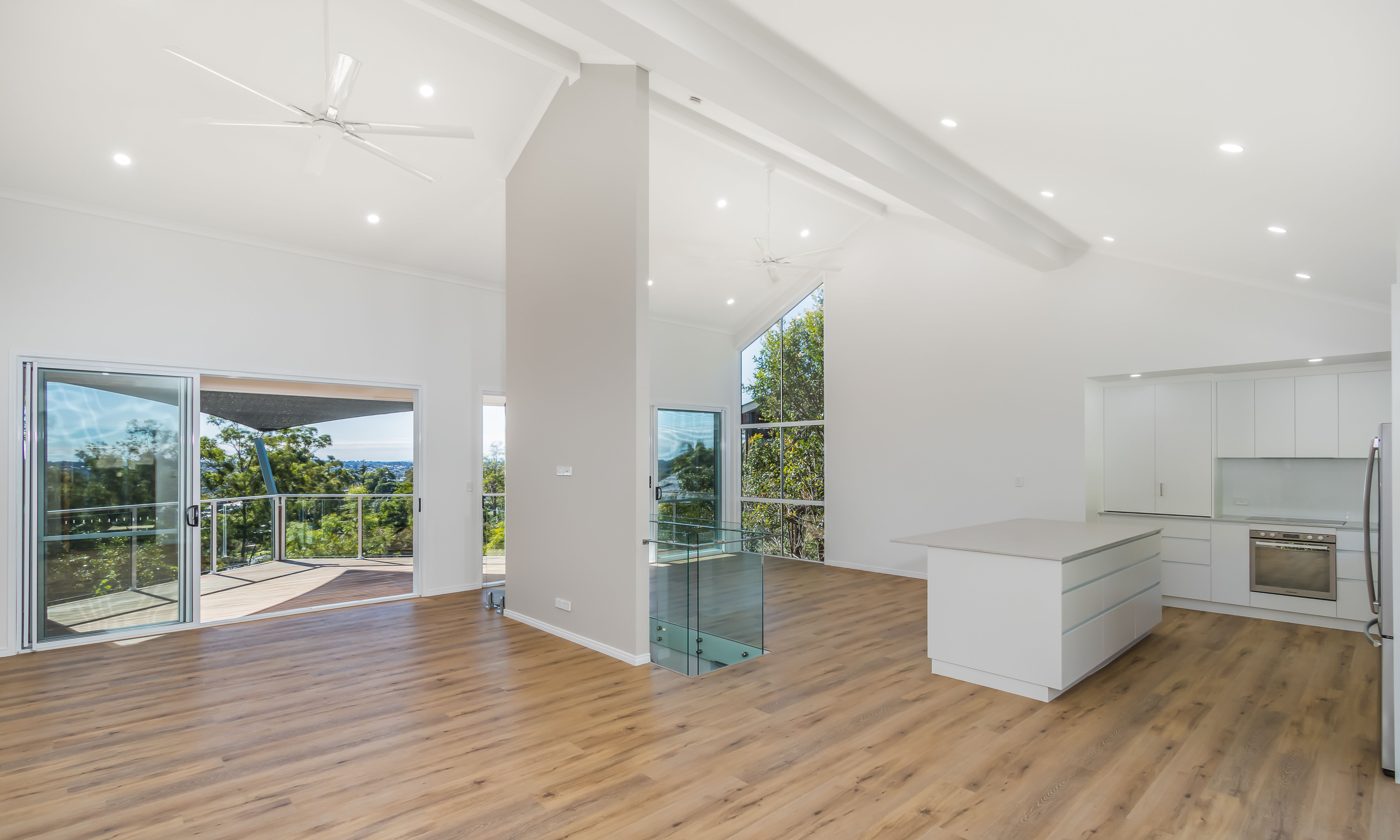 Kitchen island and deck-timber entry door-open plan living-high ceilings