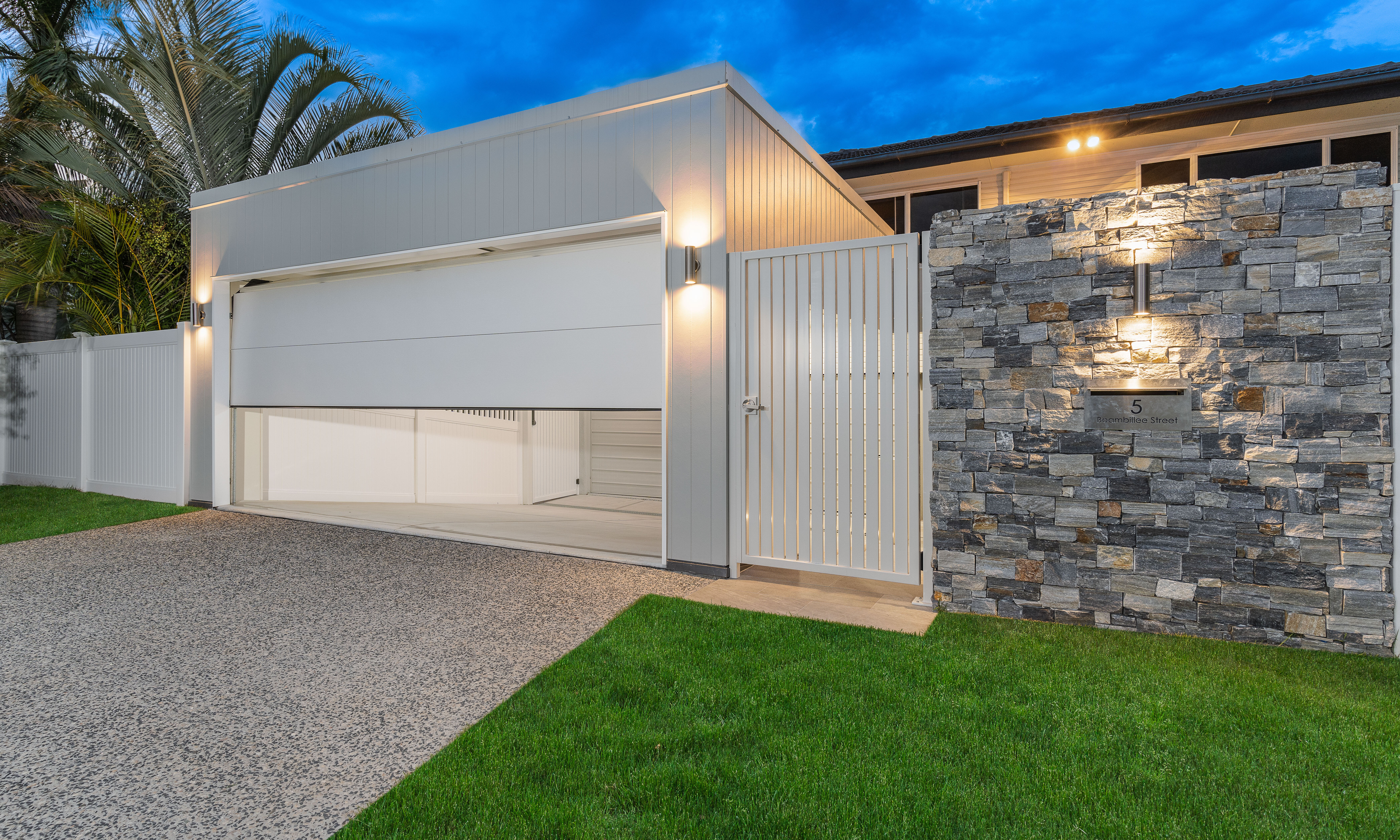 Garage door-carport-stone cladding-exposed concrete driveway