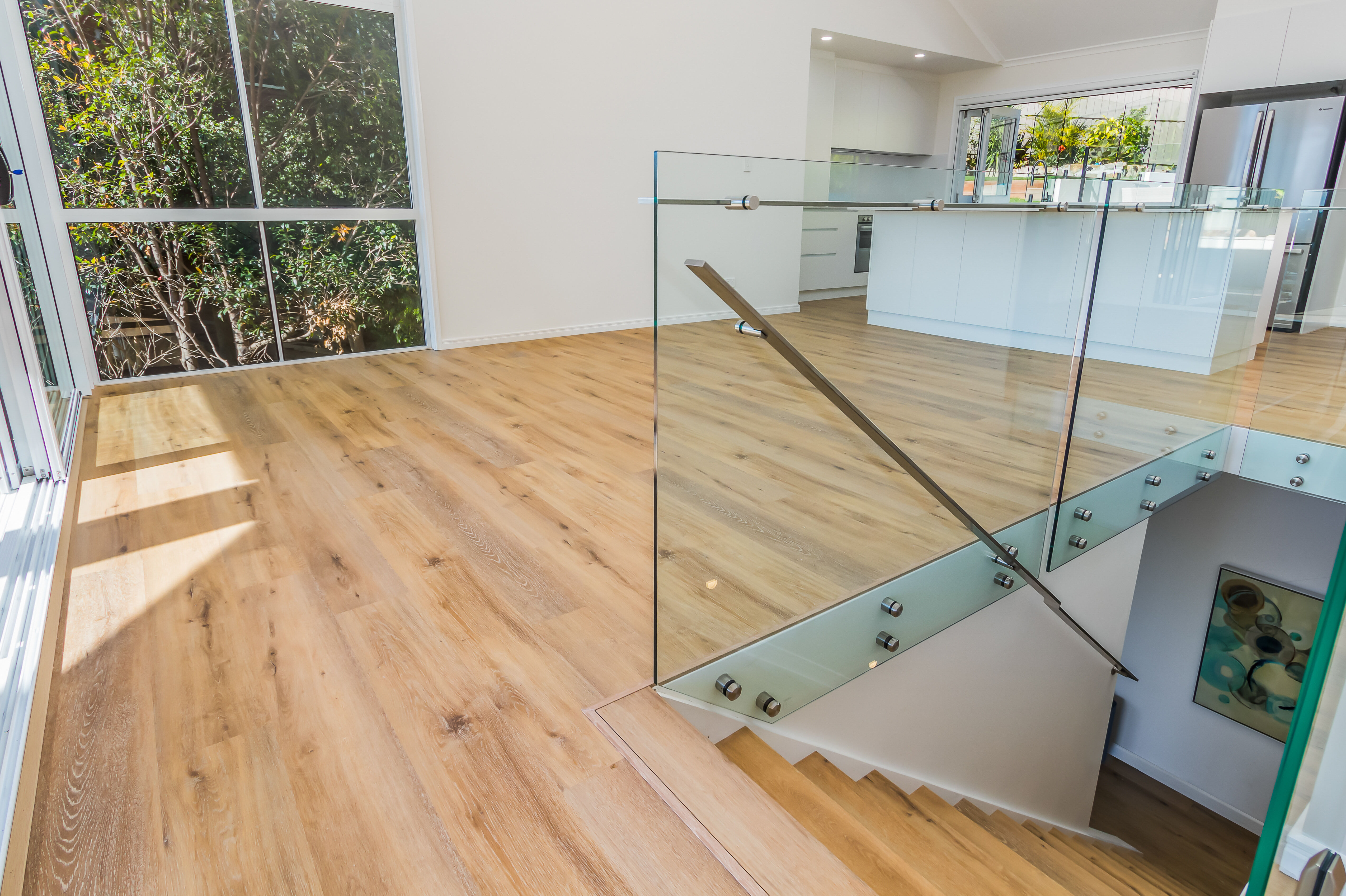 Frameless glass balustrade on standoffs-timber floors-open plan living