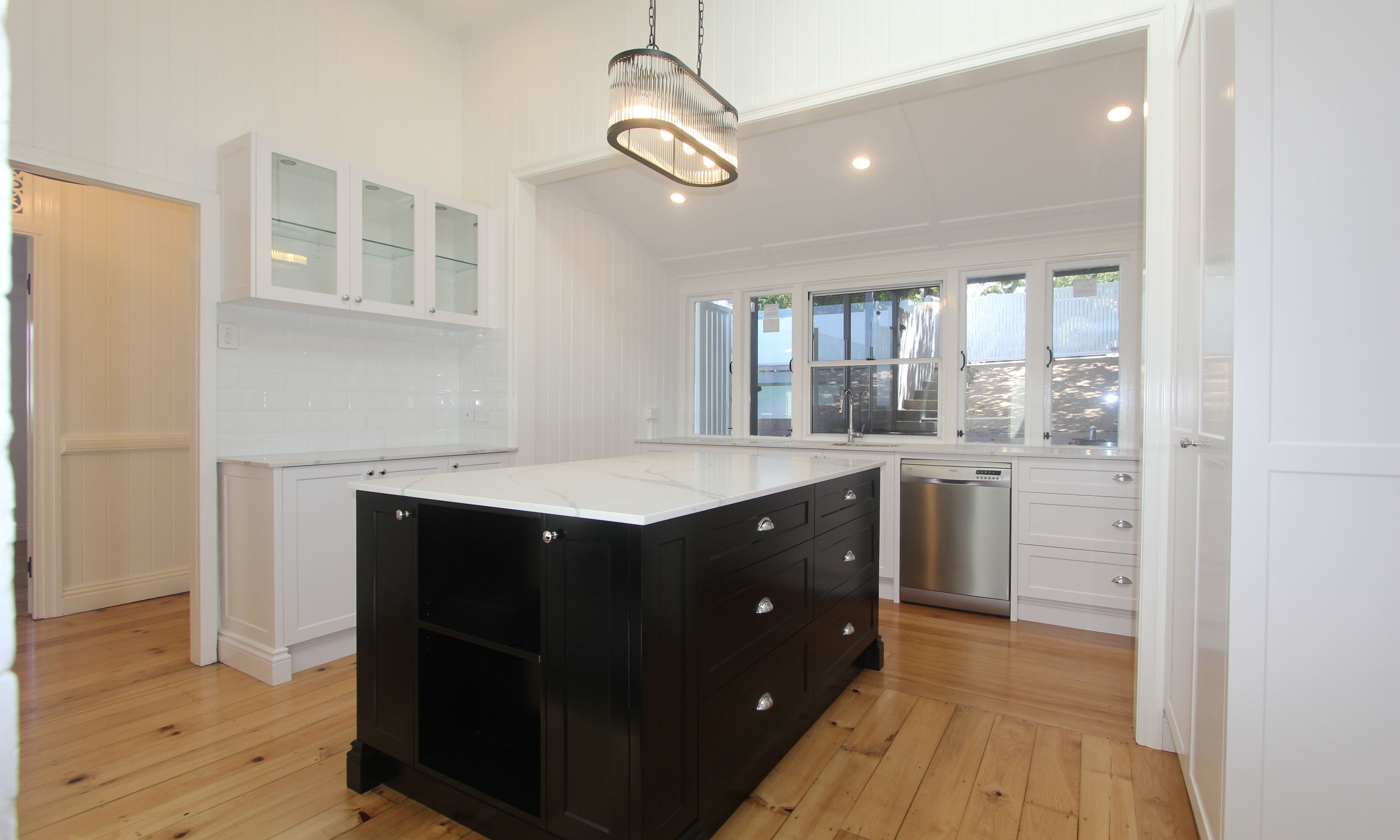 Island bench with black cabinets and marble top