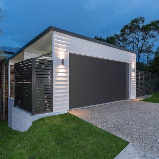 Garage door closed and white weatherboard 