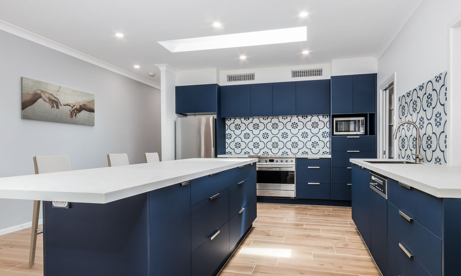 Blue kitchen with white cloudburst stone top