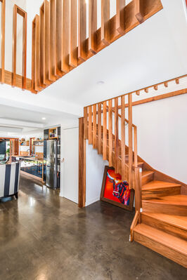 Timber stairs and black kitchen