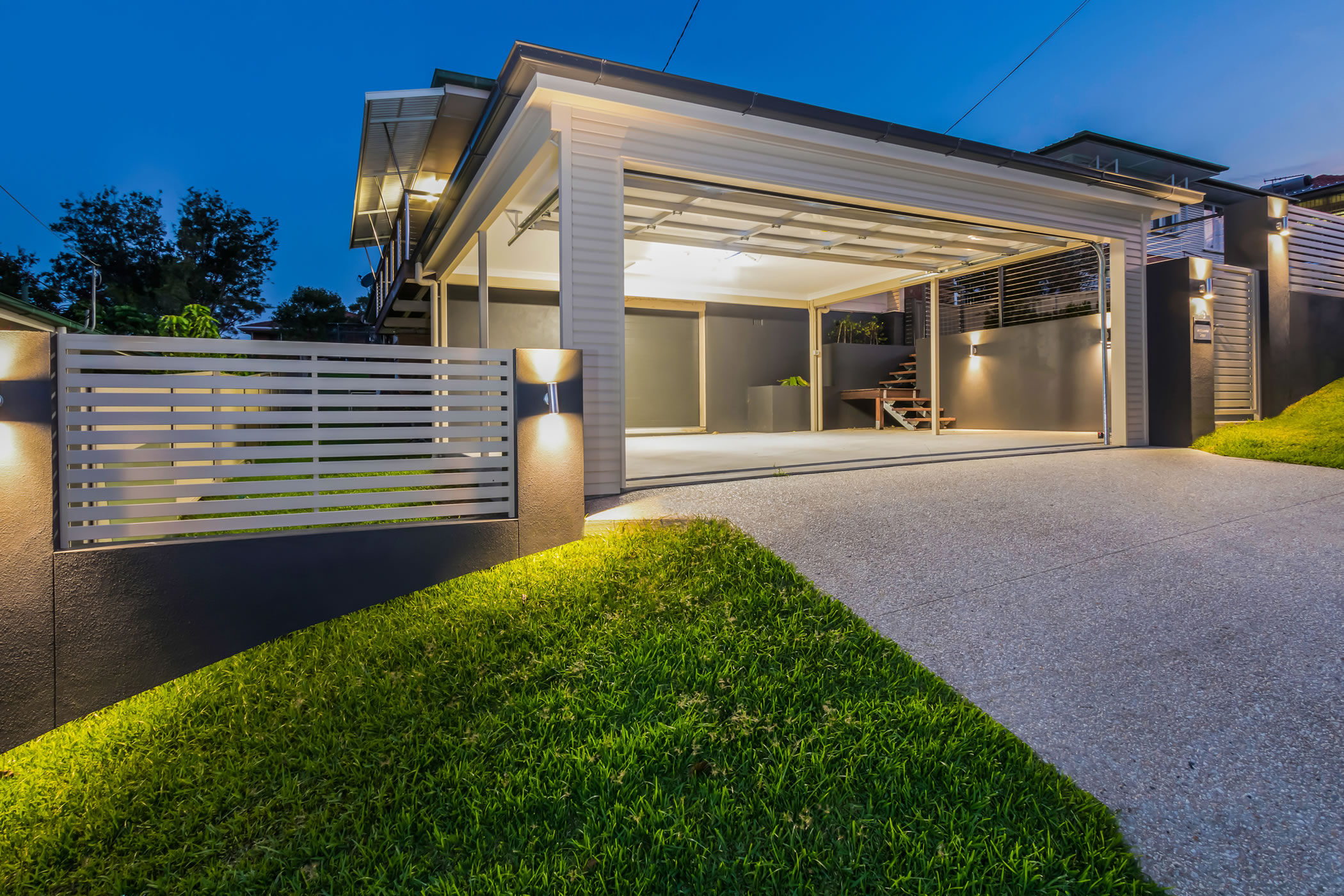 Carport and exposed concrete driveway