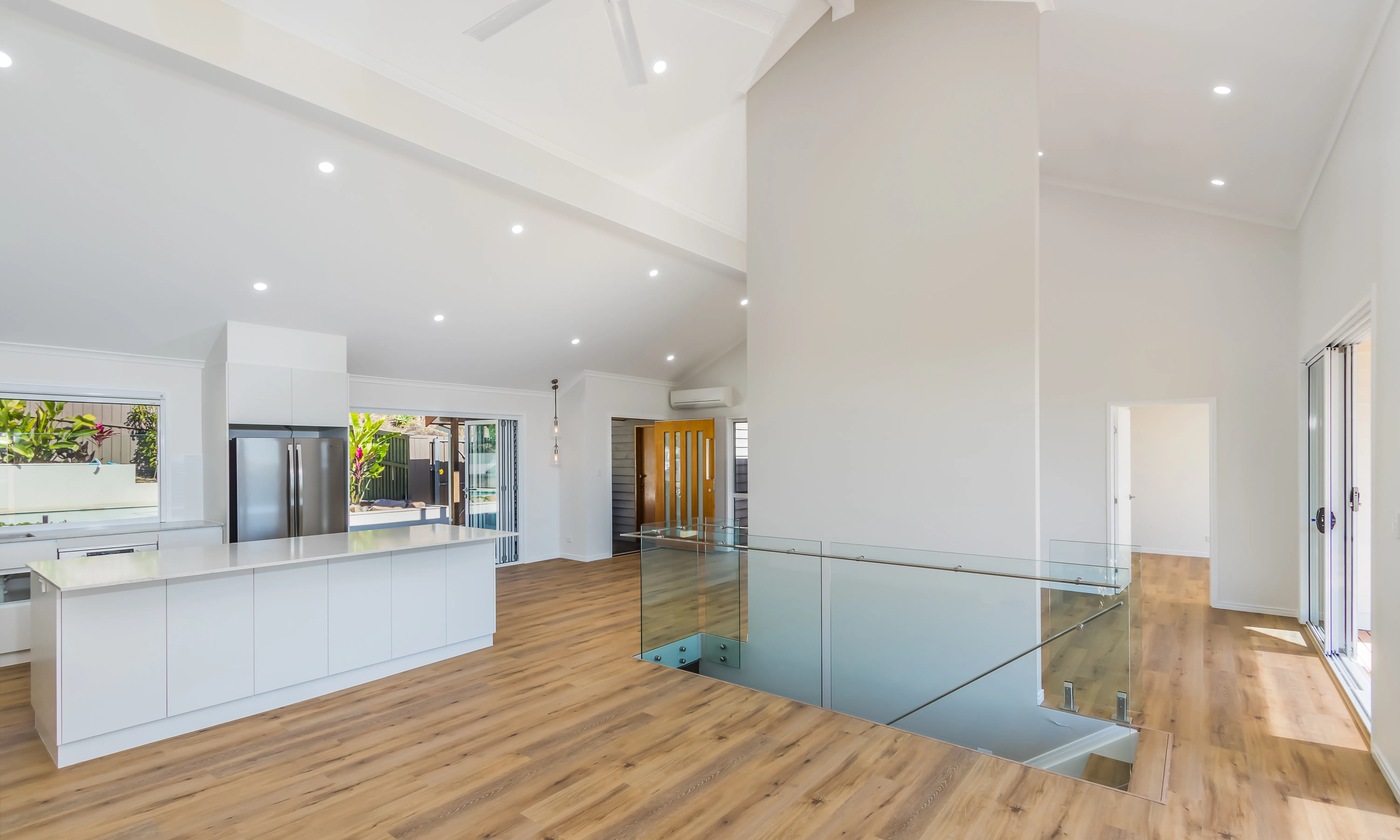 Kitchen design-bifold doors-open plan living-timber floors-white cabinets