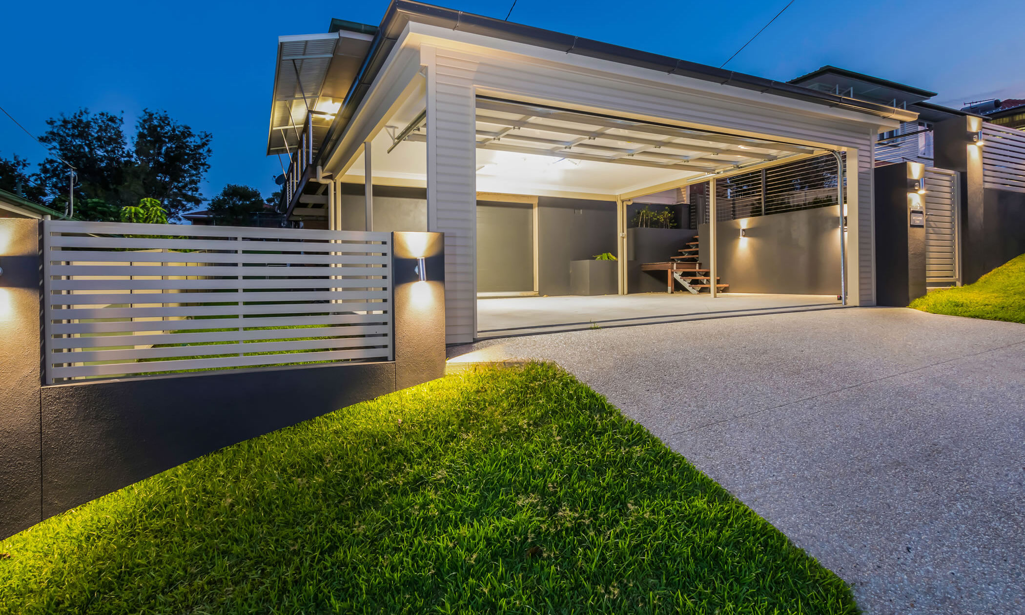 Carport and exposed concrete driveway