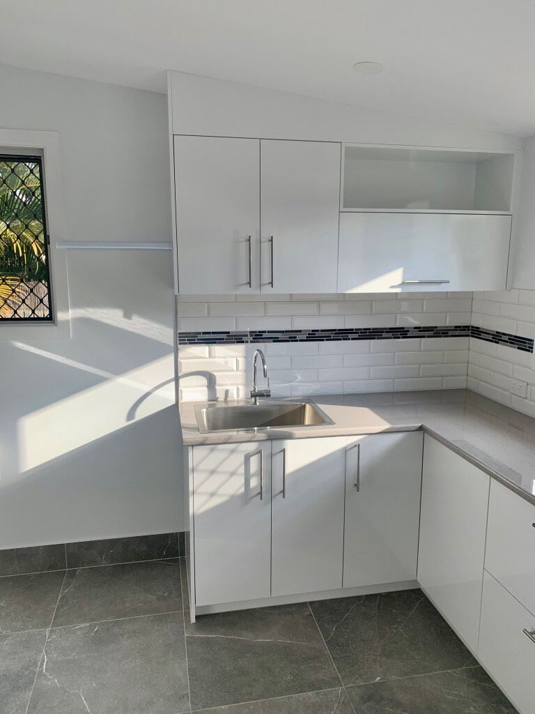 laundry renovation-floor tiles-subway tiles-white cabinets