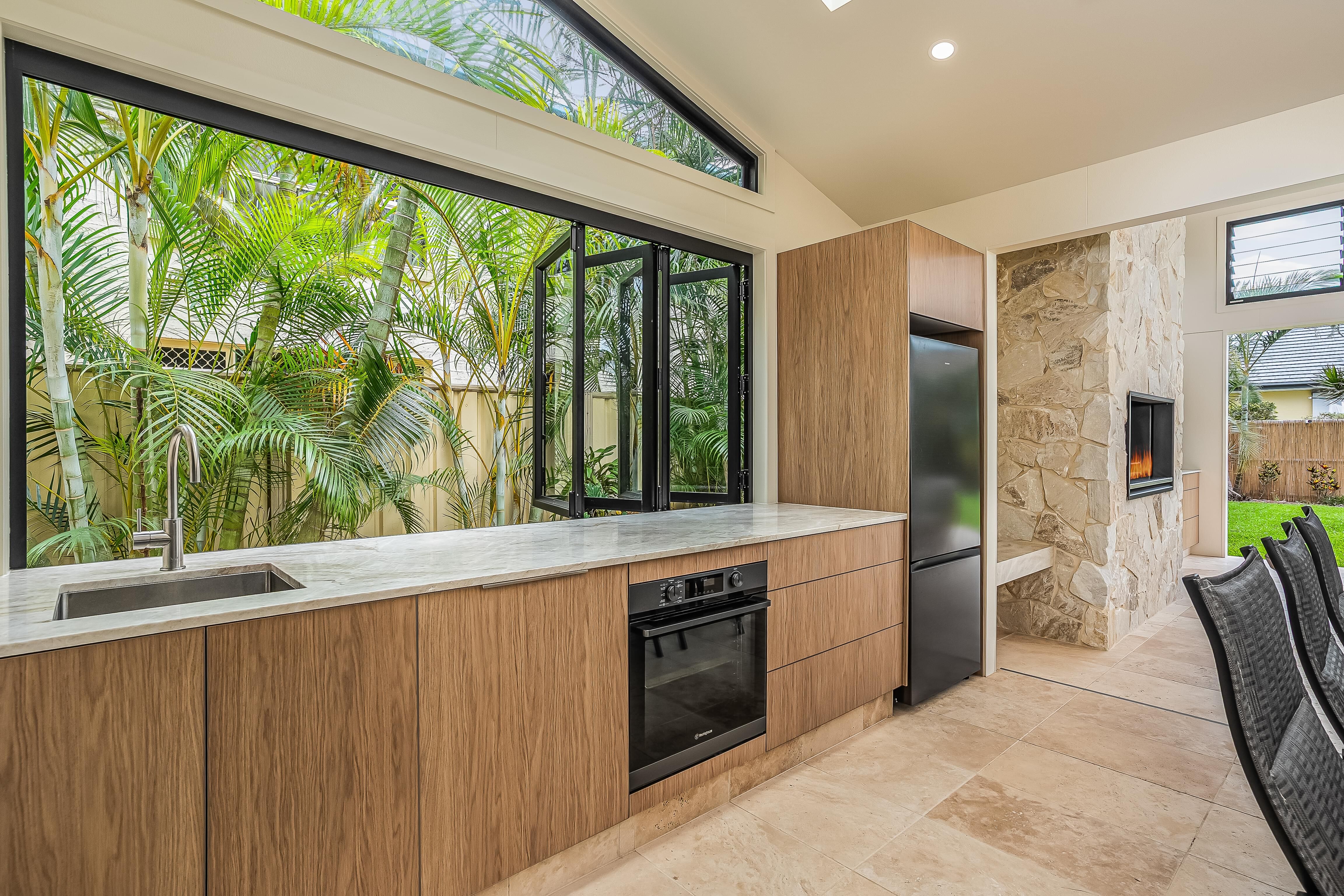Sweetapple - Outdoor kitchen, Bifold indows, feature cladding, travertine tiles