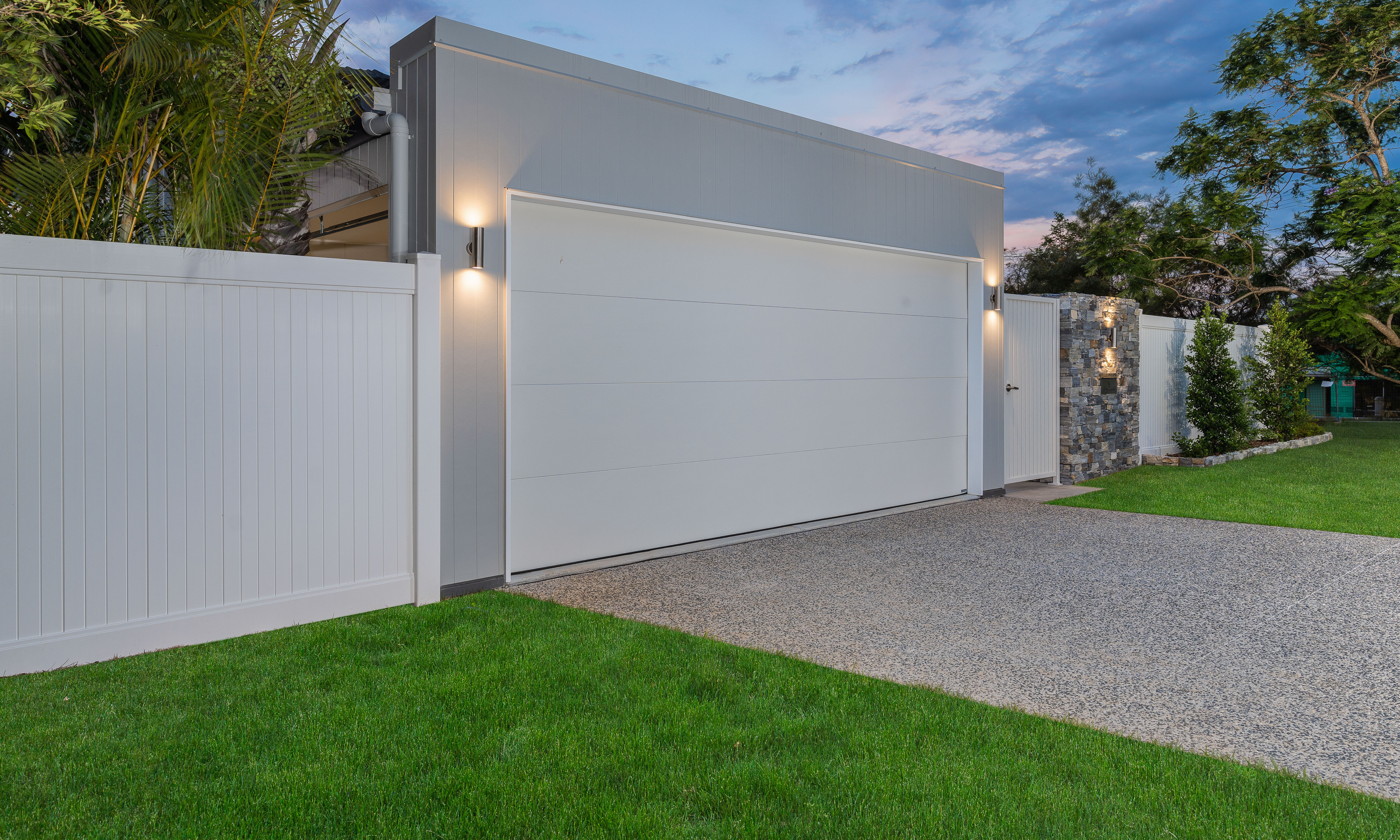 Garage door-carport-stone cladding-exposed concrete driveway