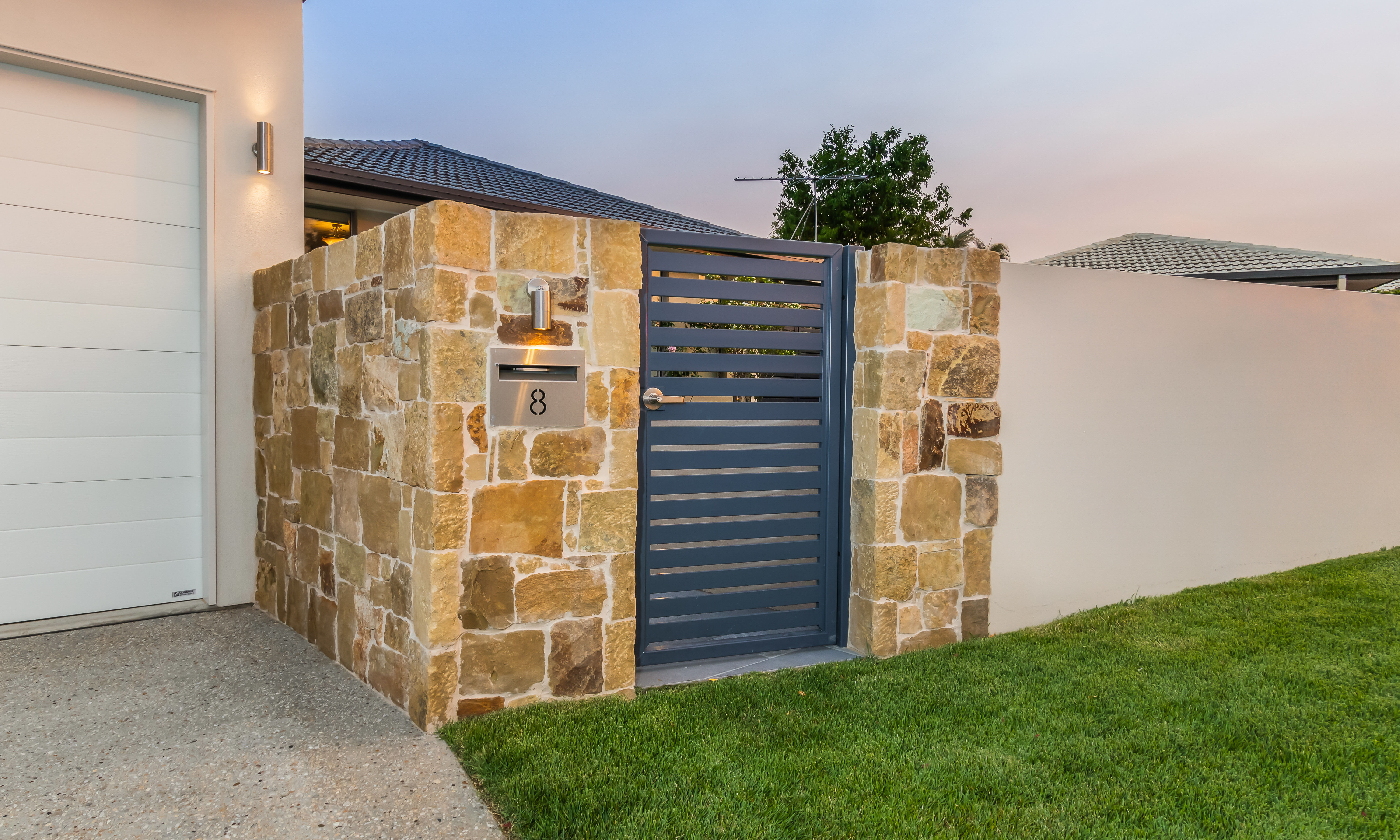 Clancy wall cladding feature to rendered wall fence with Brilliant Vista II fixed spot light above stainless steel letterbox