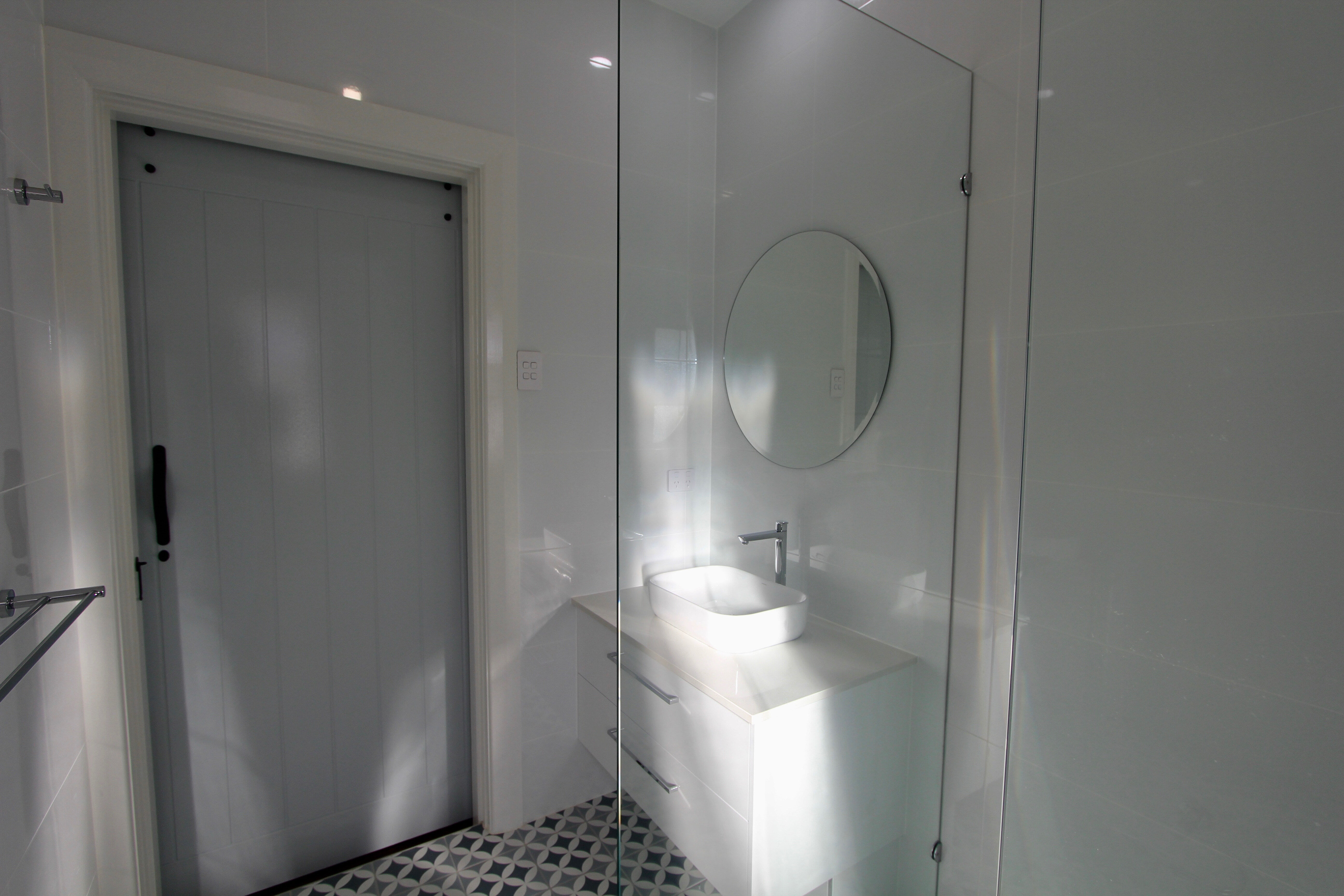 Blue tiles in bathroom wth barn door