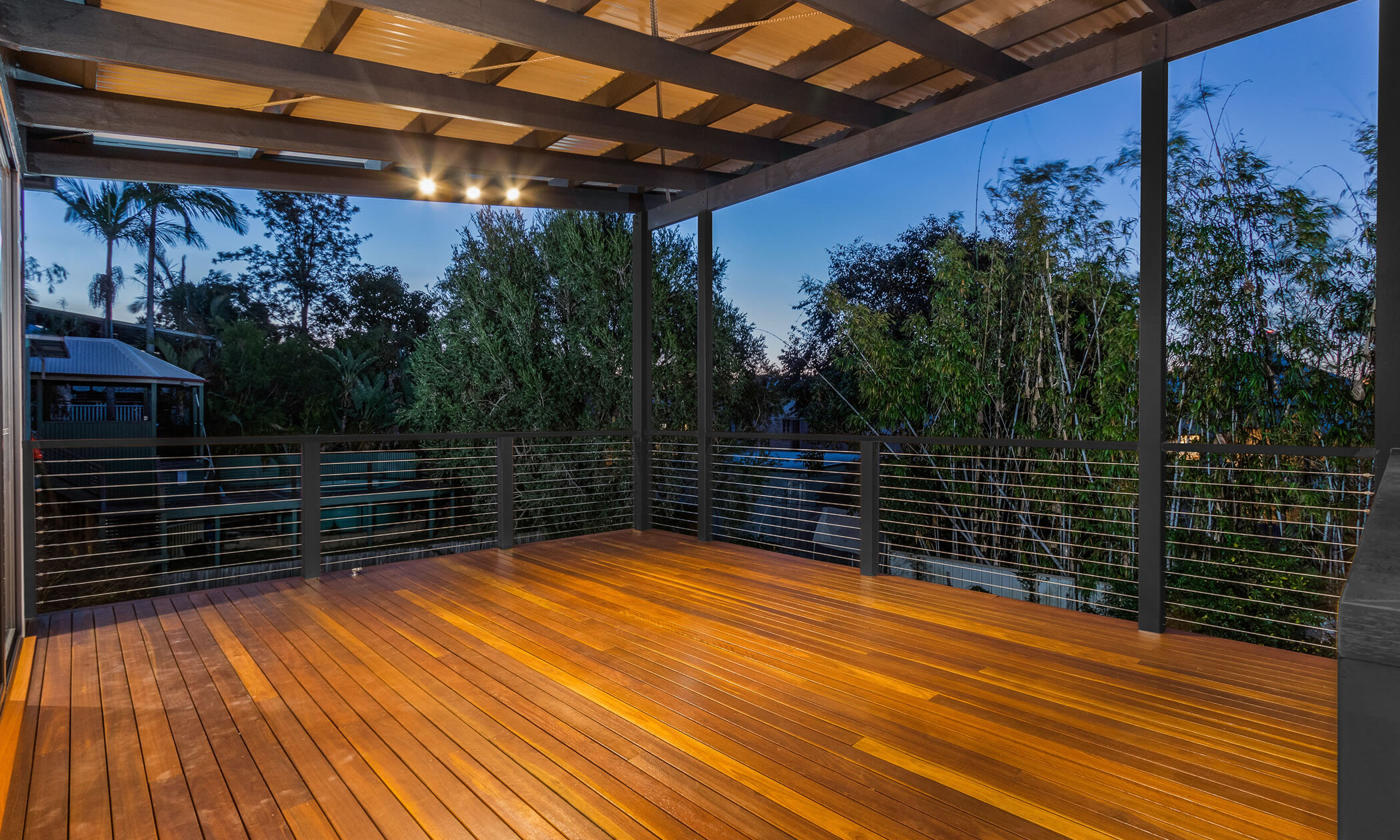 Large deck with Spotted Gum decking boards and wire balustrade 