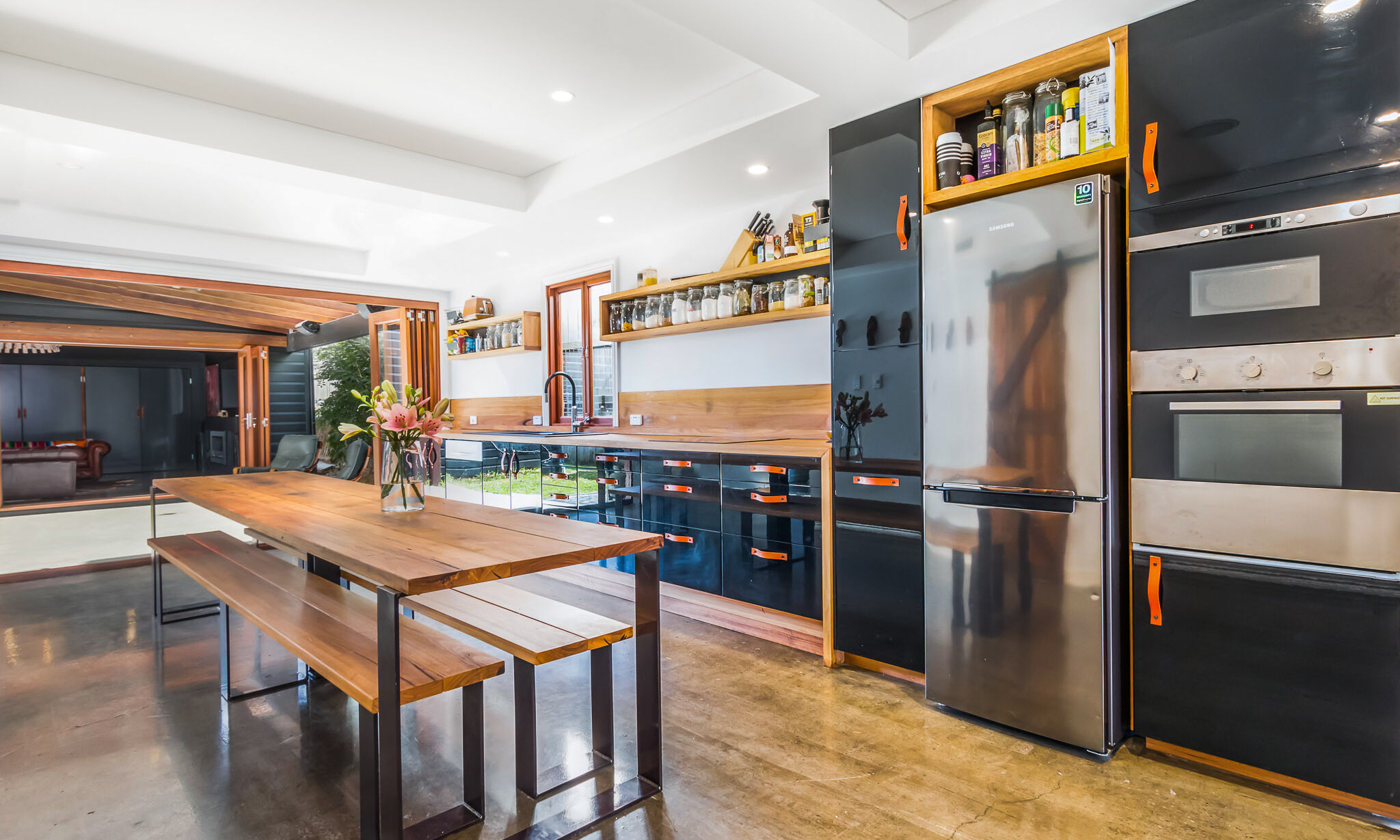 Black kitchen with leather pull handles