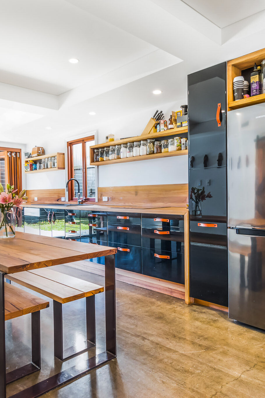 Black kitchen with leather pull handles