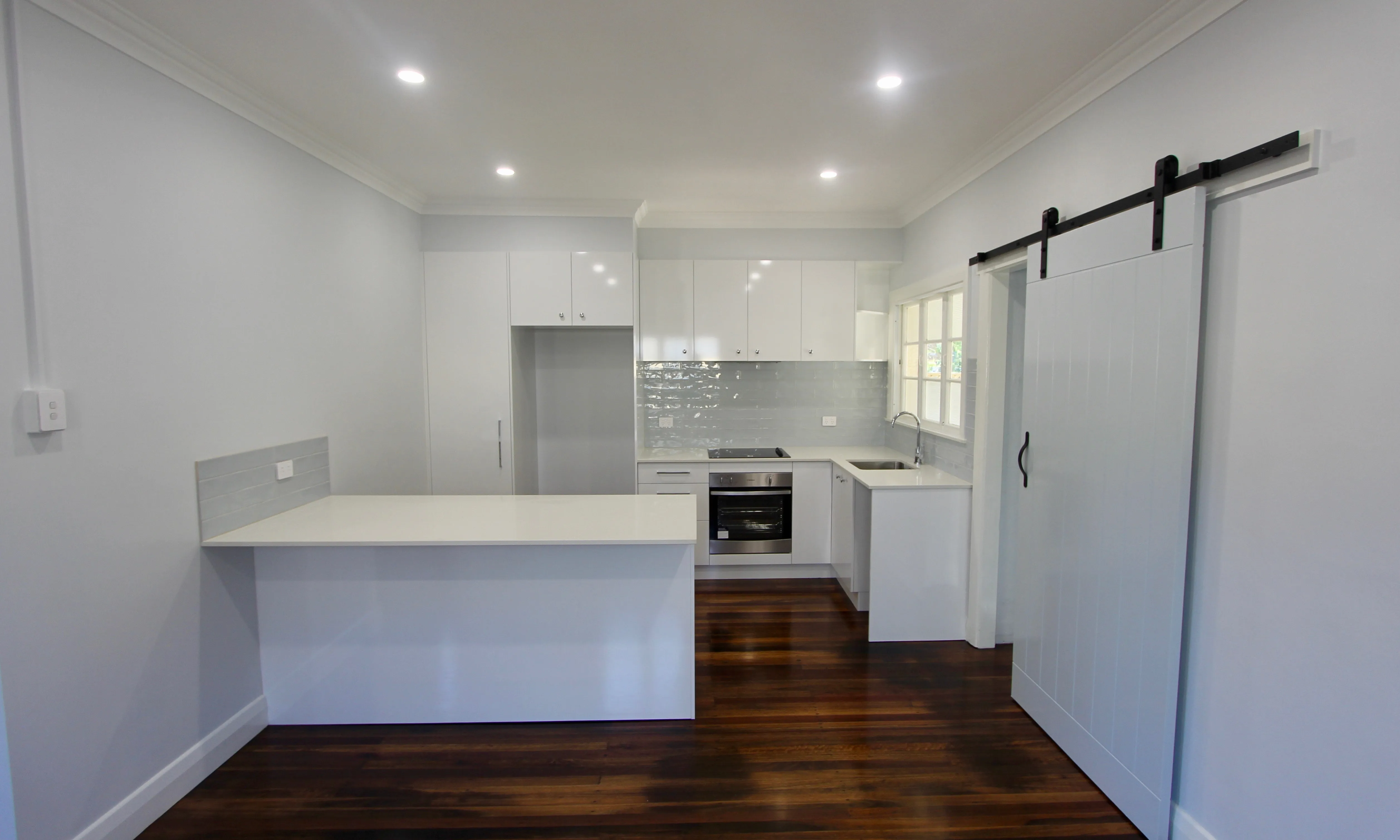 Kitchen renovation-subway tiles-timber flooring-white cabinets