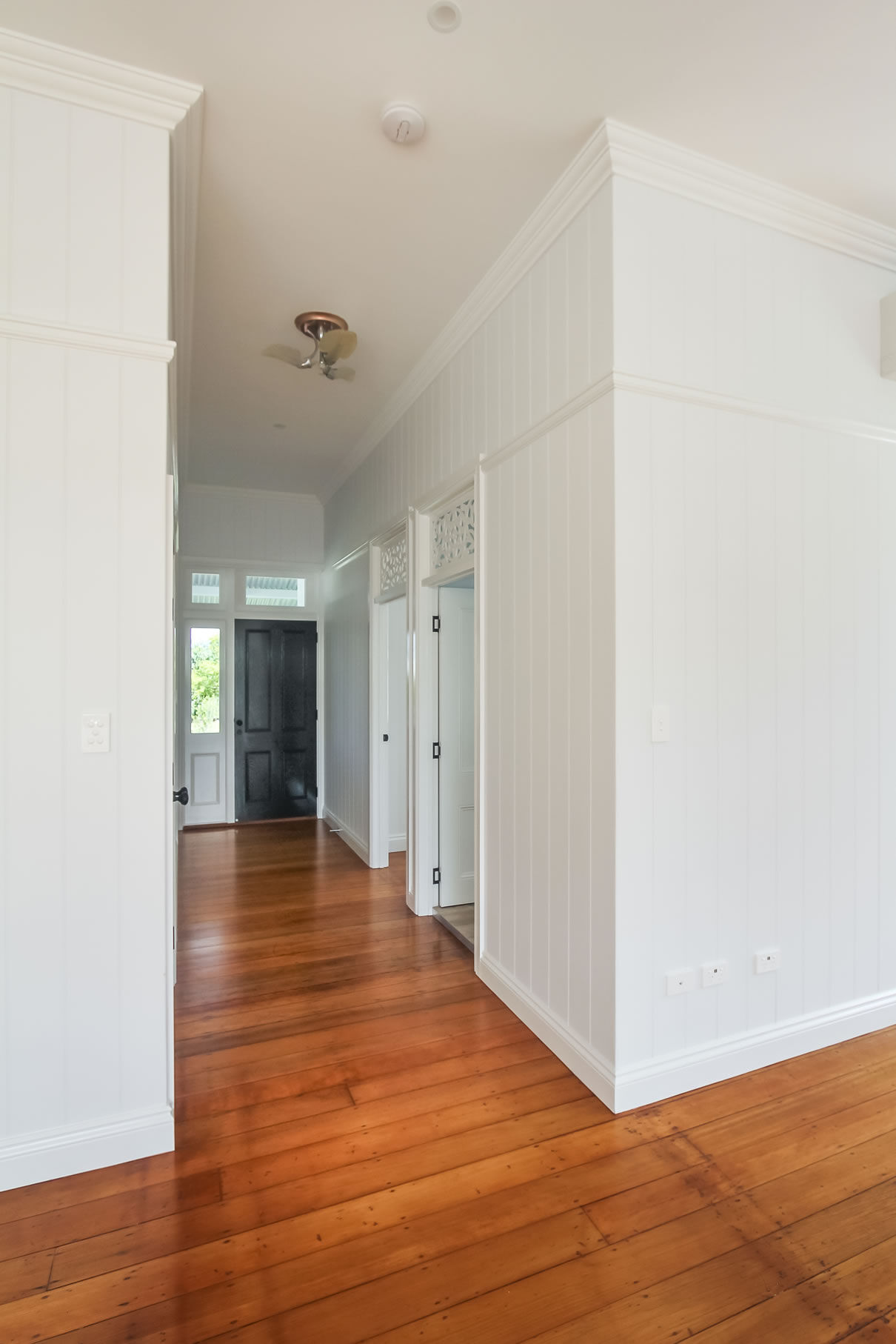 Front entry with VJ wall paneling and Fretwork above doors