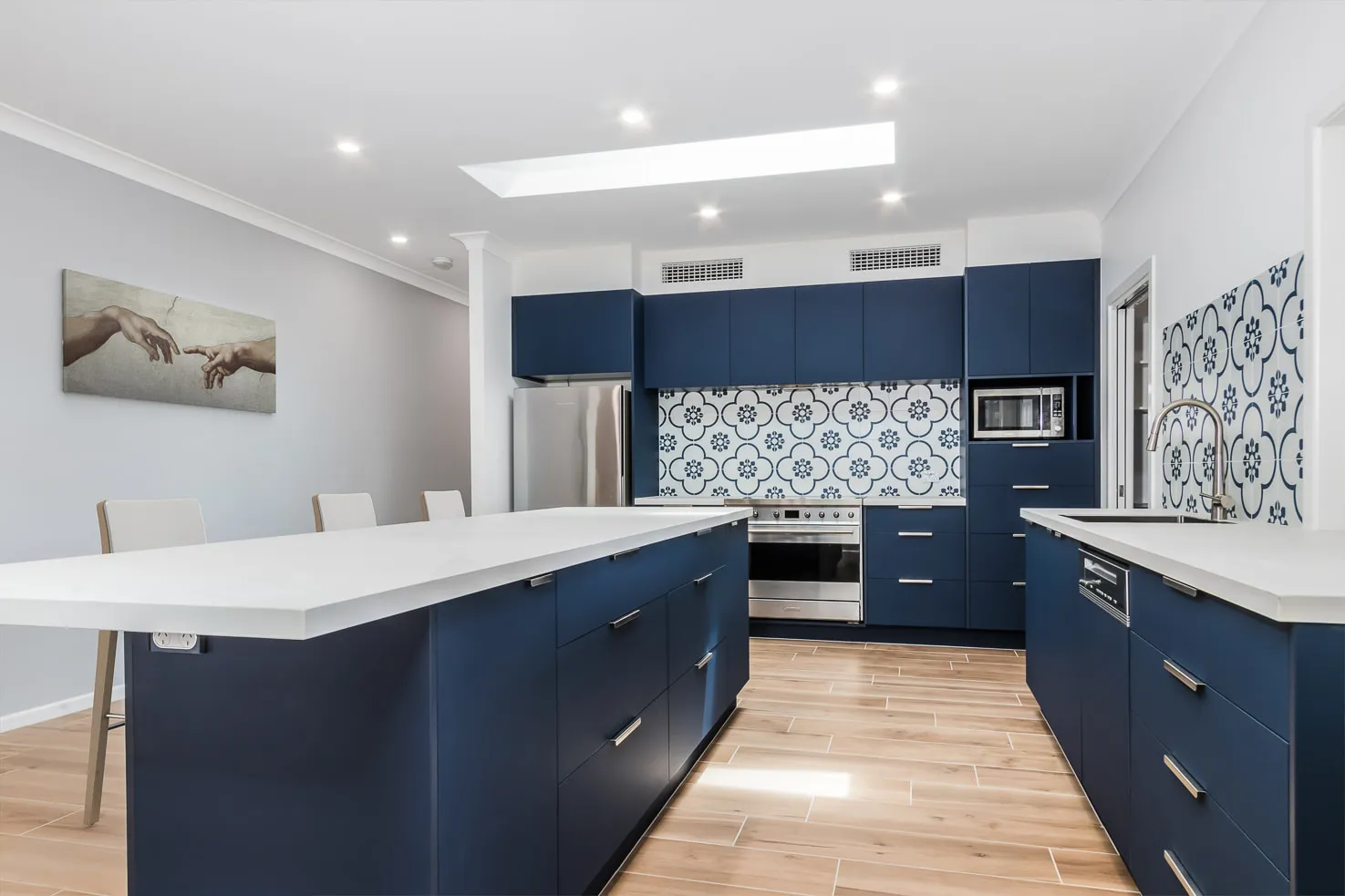 Blue kitchen with white cloudburst stone top