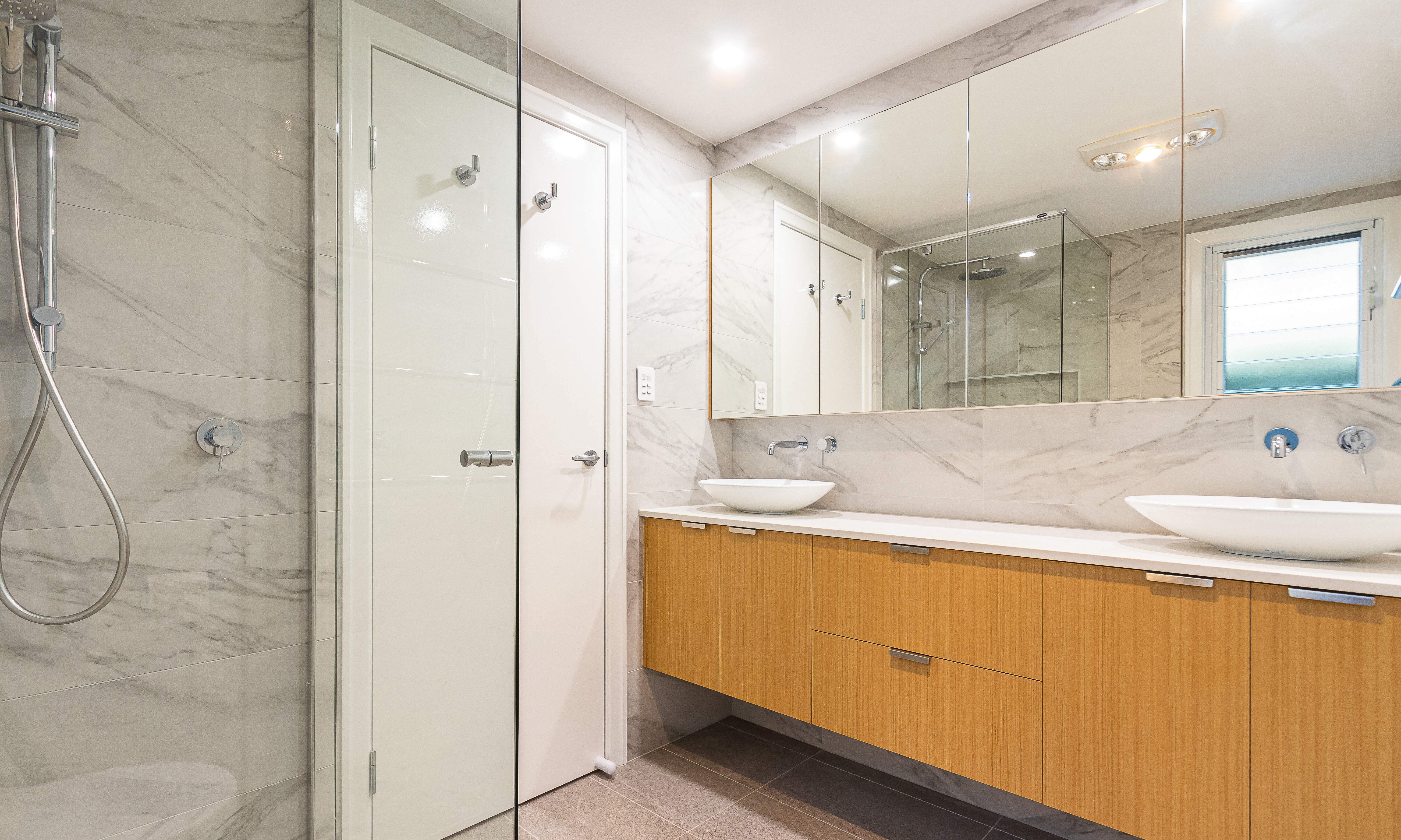 Double above counter basins and floating vanity in Norman Park