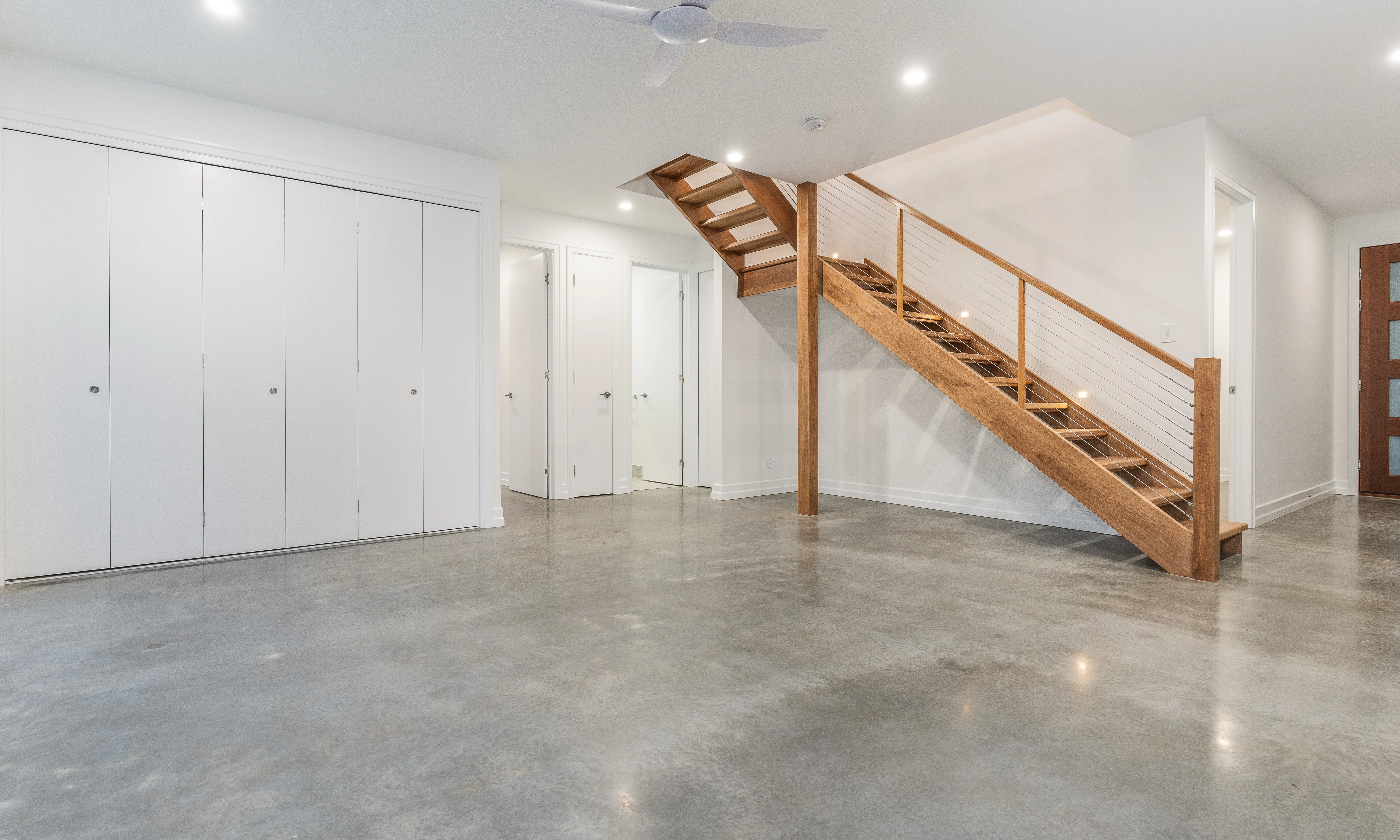 polished concrete floors-bifold doors-wire balustrade-timber handrail- timber stairs