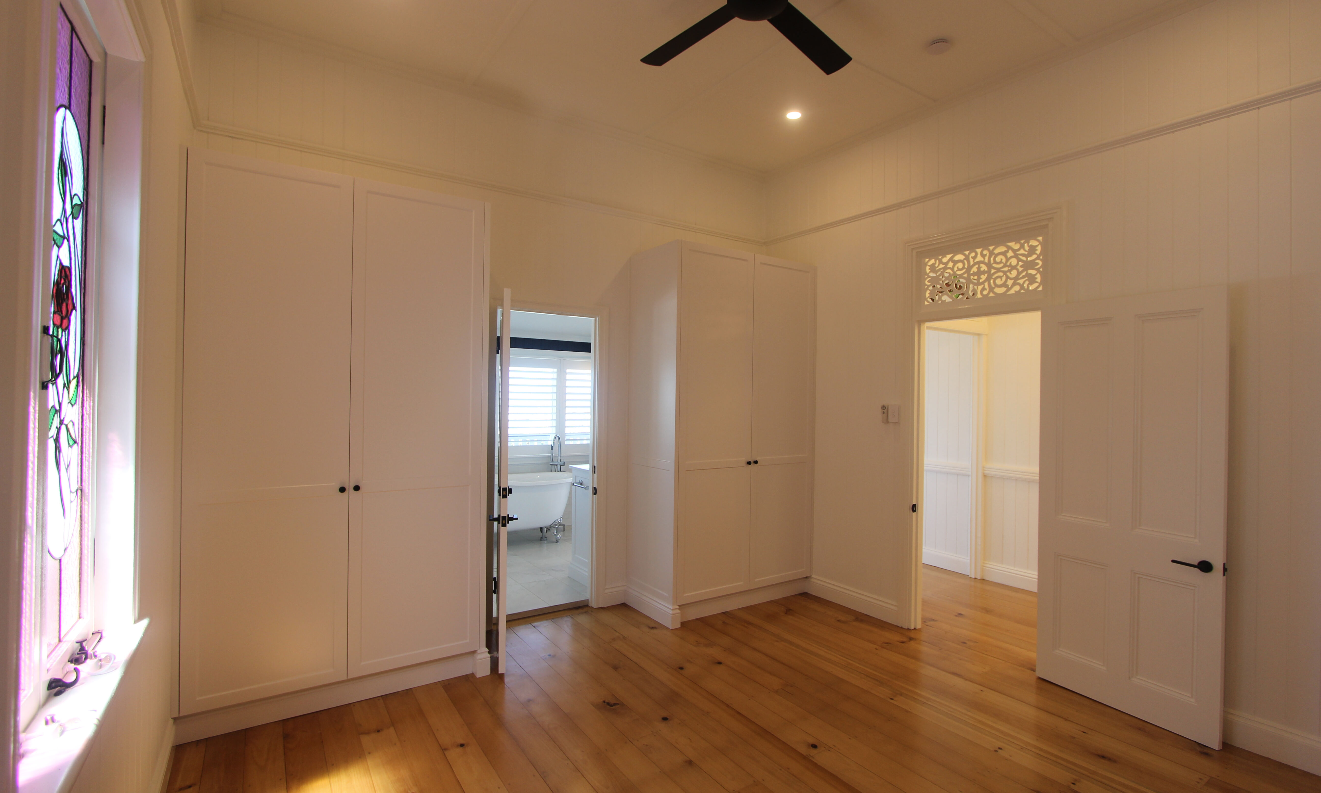 Black and white cabinetry-pine floorboards