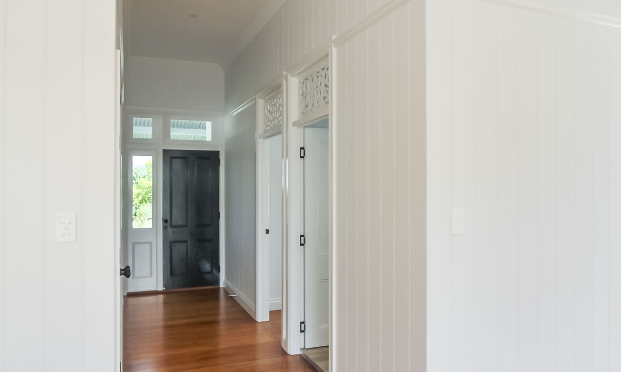 Front entry with VJ wall paneling and Fretwork above doors