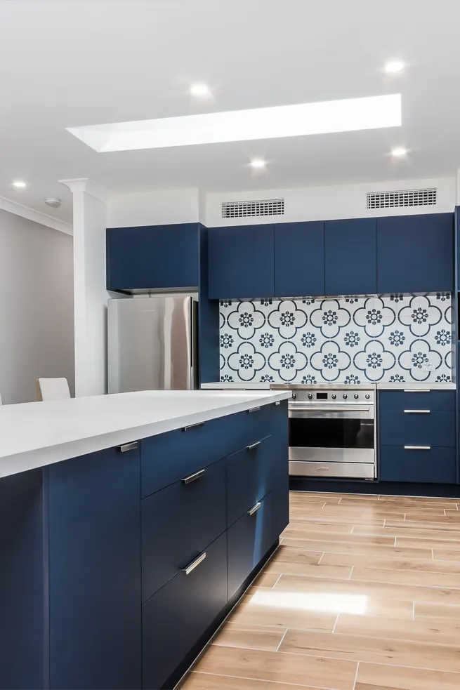 Blue kitchen with white cloudburst stone top