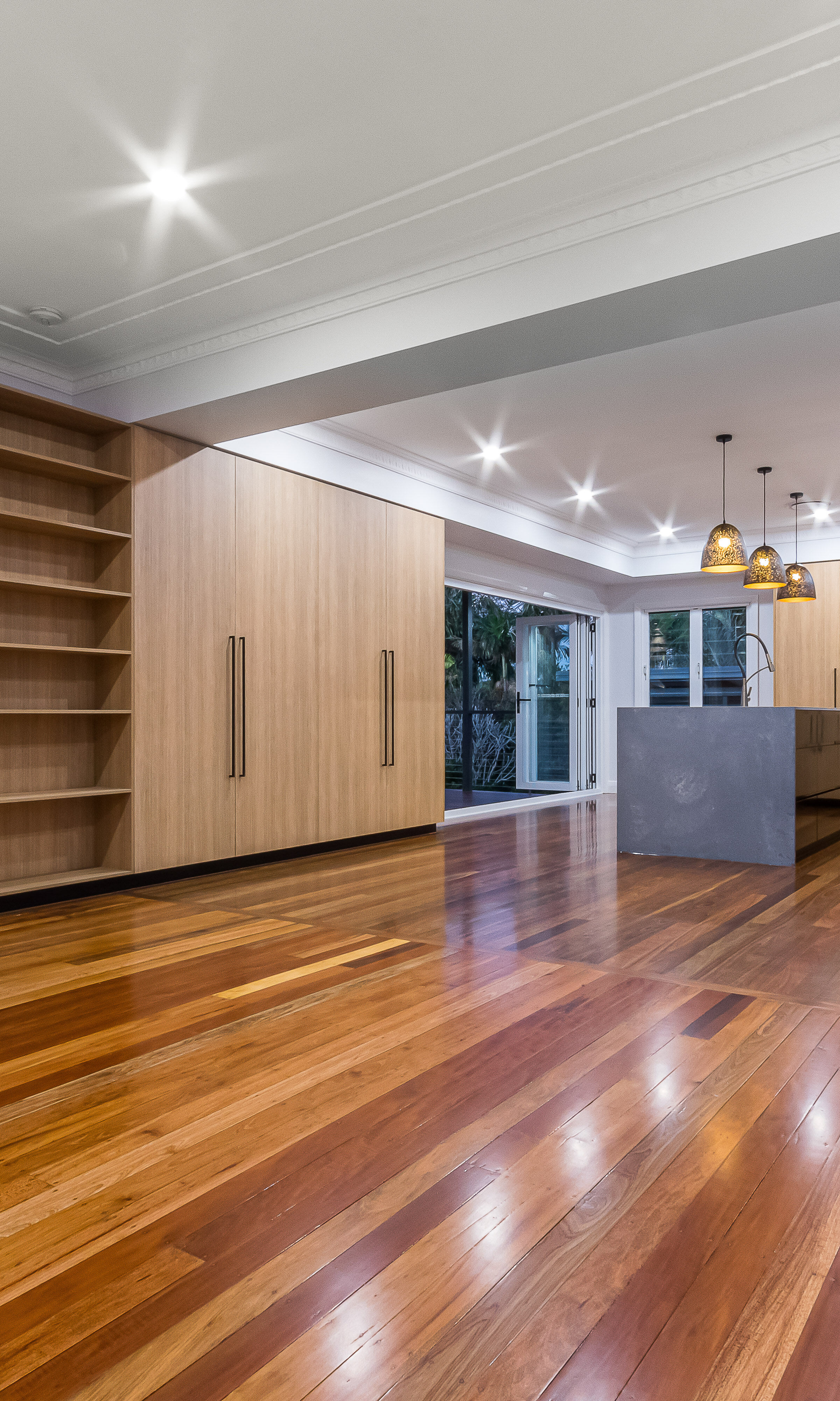 timber kitchen-stone benchtop- timber flooring- black handles- black cabinets