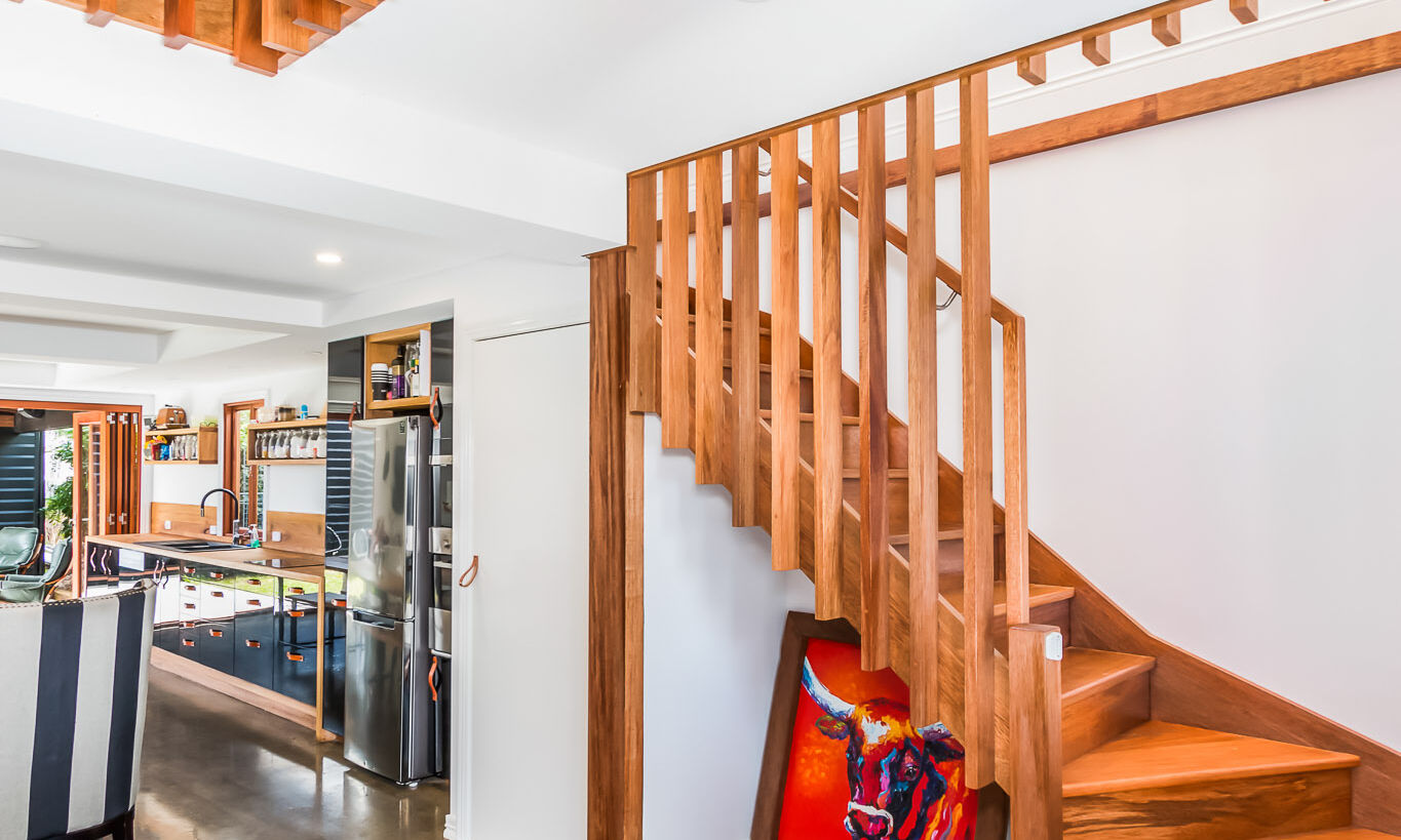 Timber stairs and black kitchen