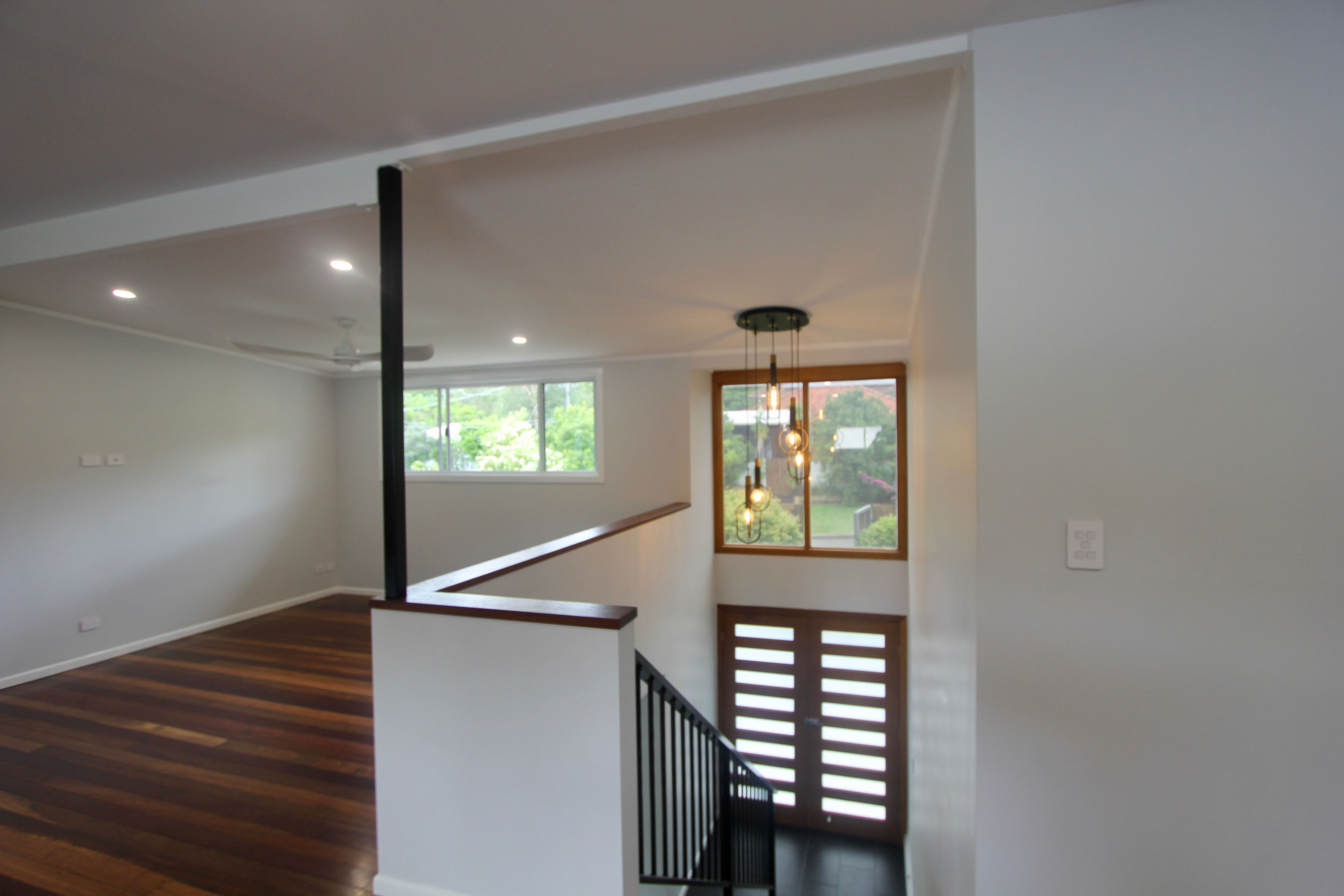 Double doors in front entry and stairs with powder coated dowel balustrade