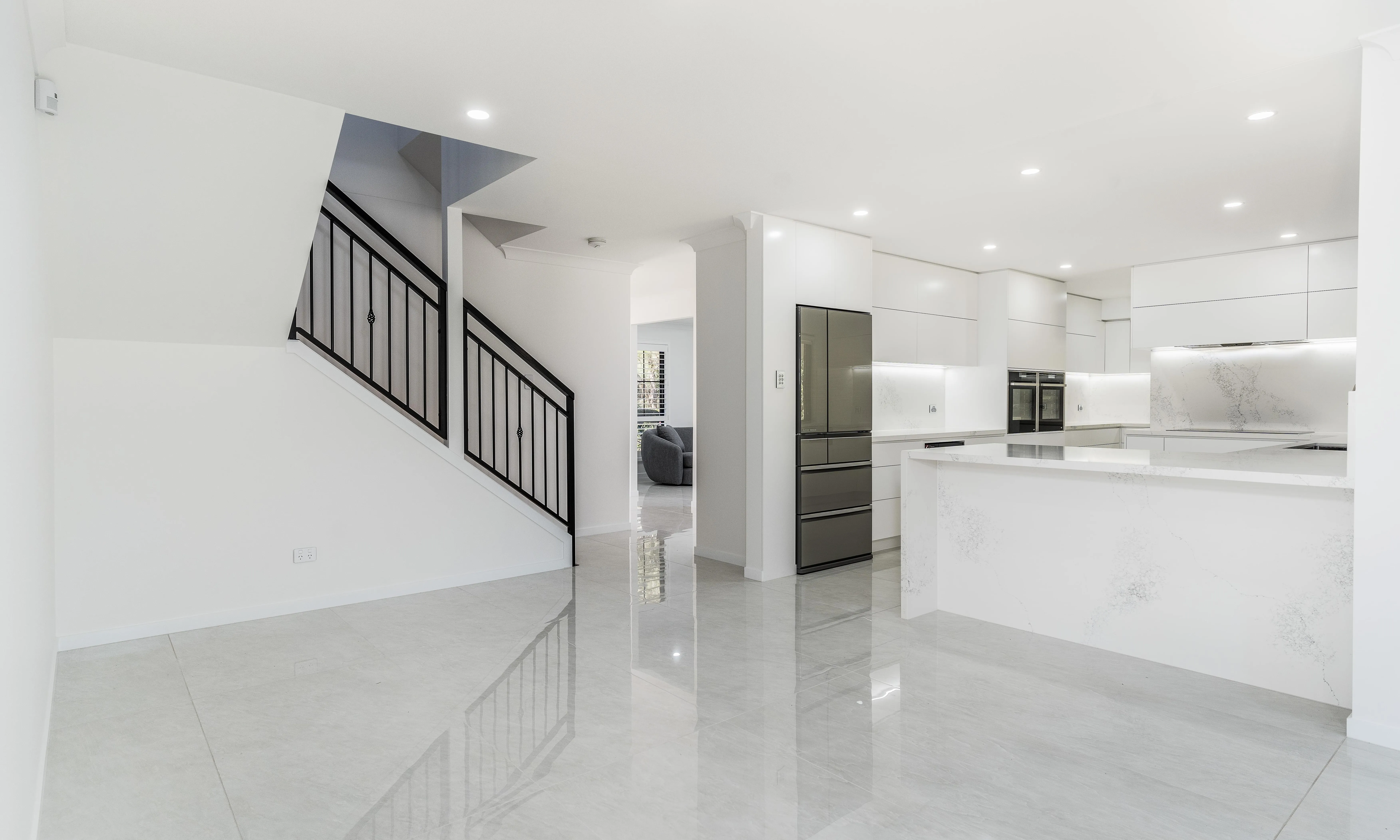 Cardwell St, Main living area, polished floor tiles, white  kitchen, white caesarstone top