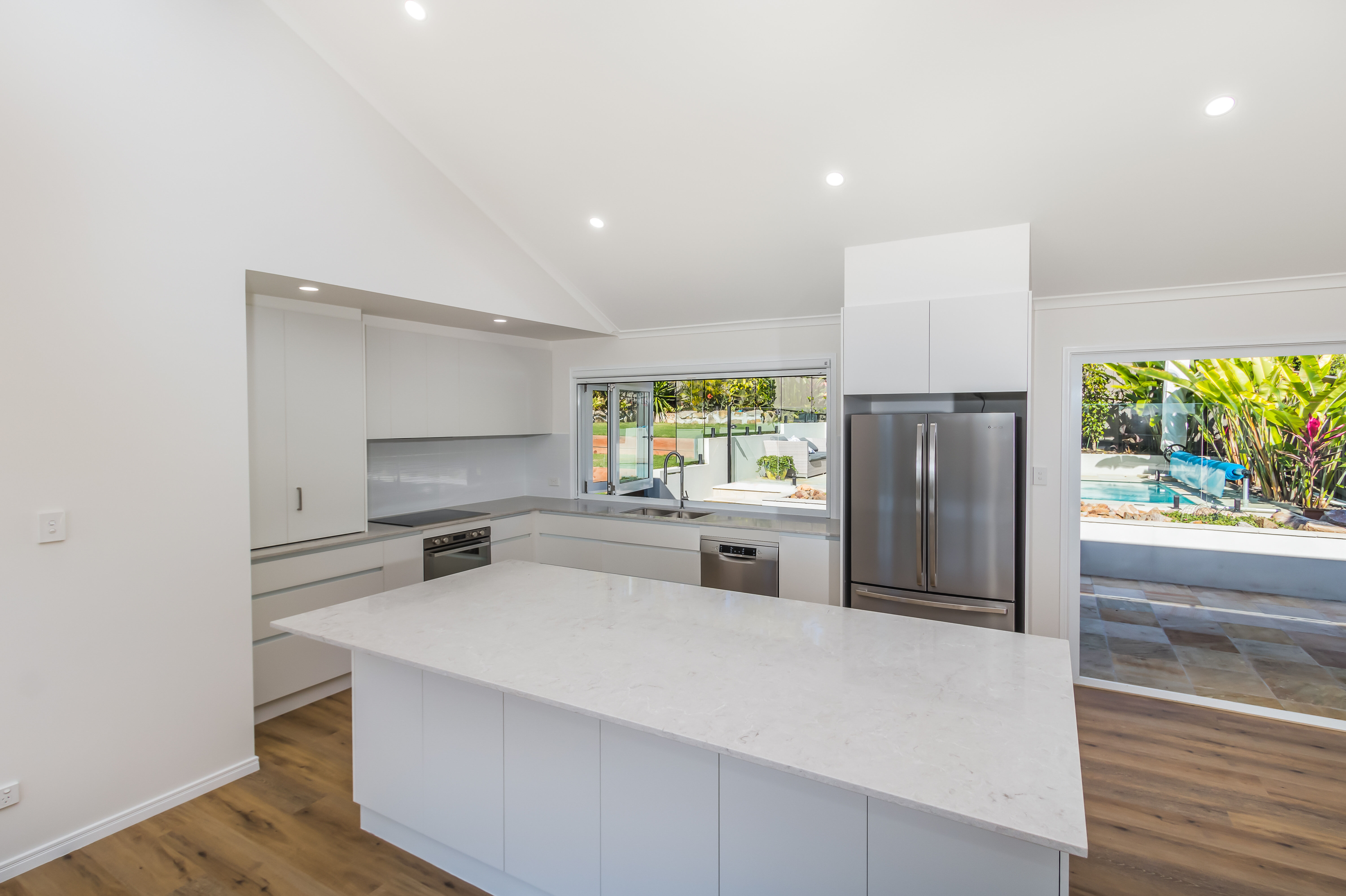 Kitchen with stone tops and finger pull cabinetry