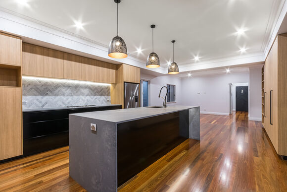 timber kitchen-stone benchtop- timber flooring- black handles- black cabinets-marble tiles